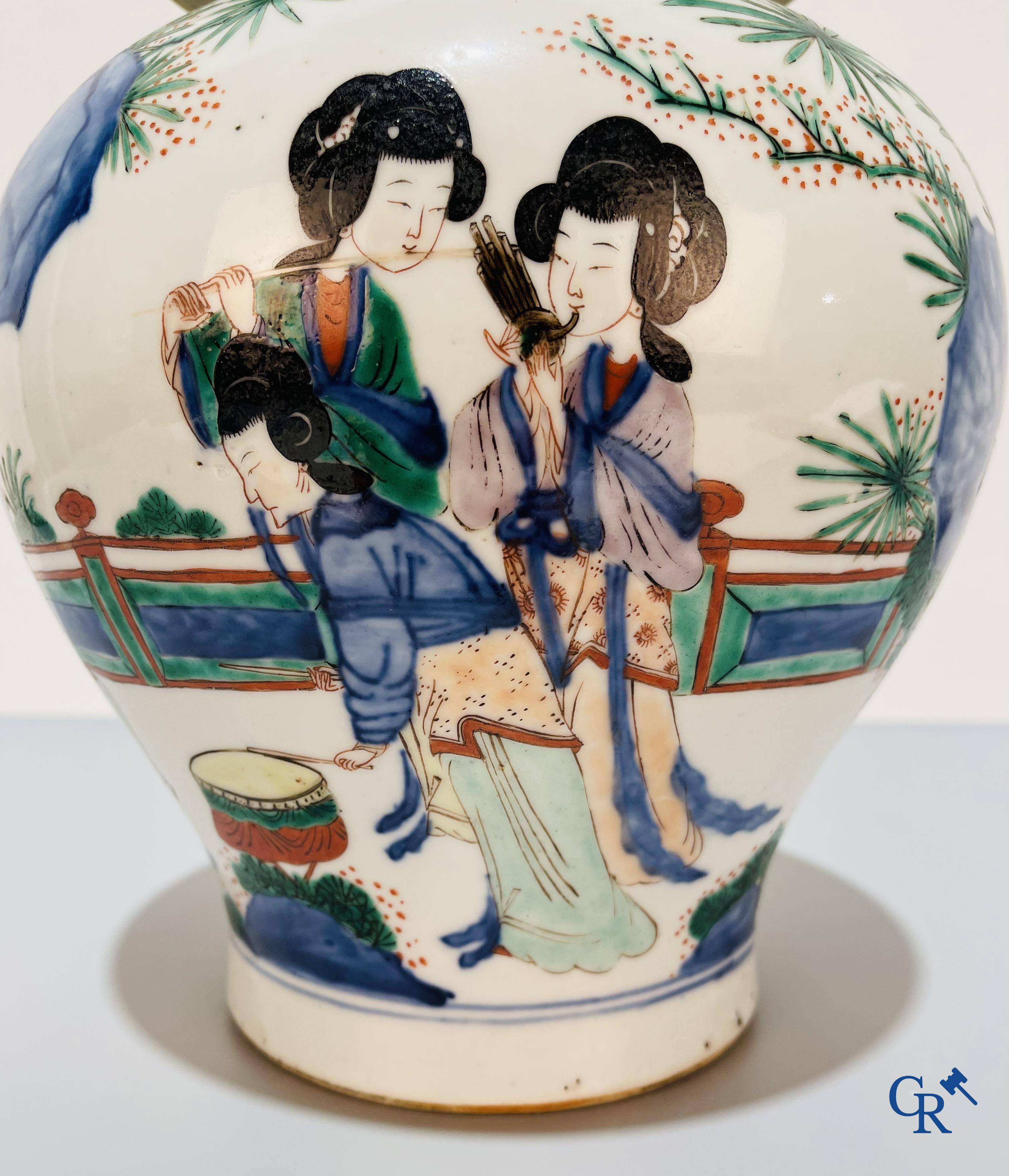 Asian Art, Chinese porcelain, a Chinese Wucai lidded vase with characters.