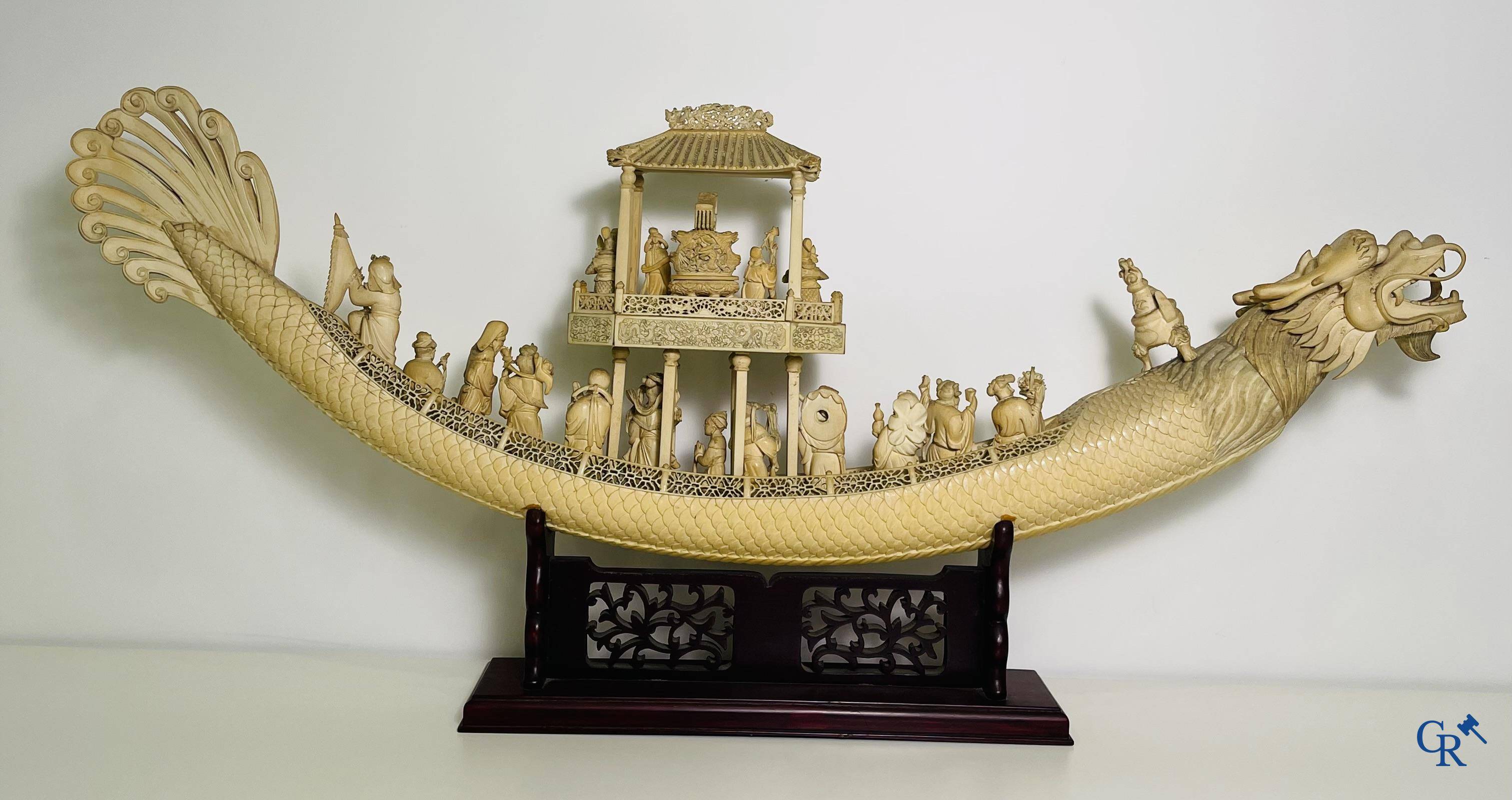 Asian Art: A large Chinese ivory dragon boat on a wooden pedestal. 19th century.