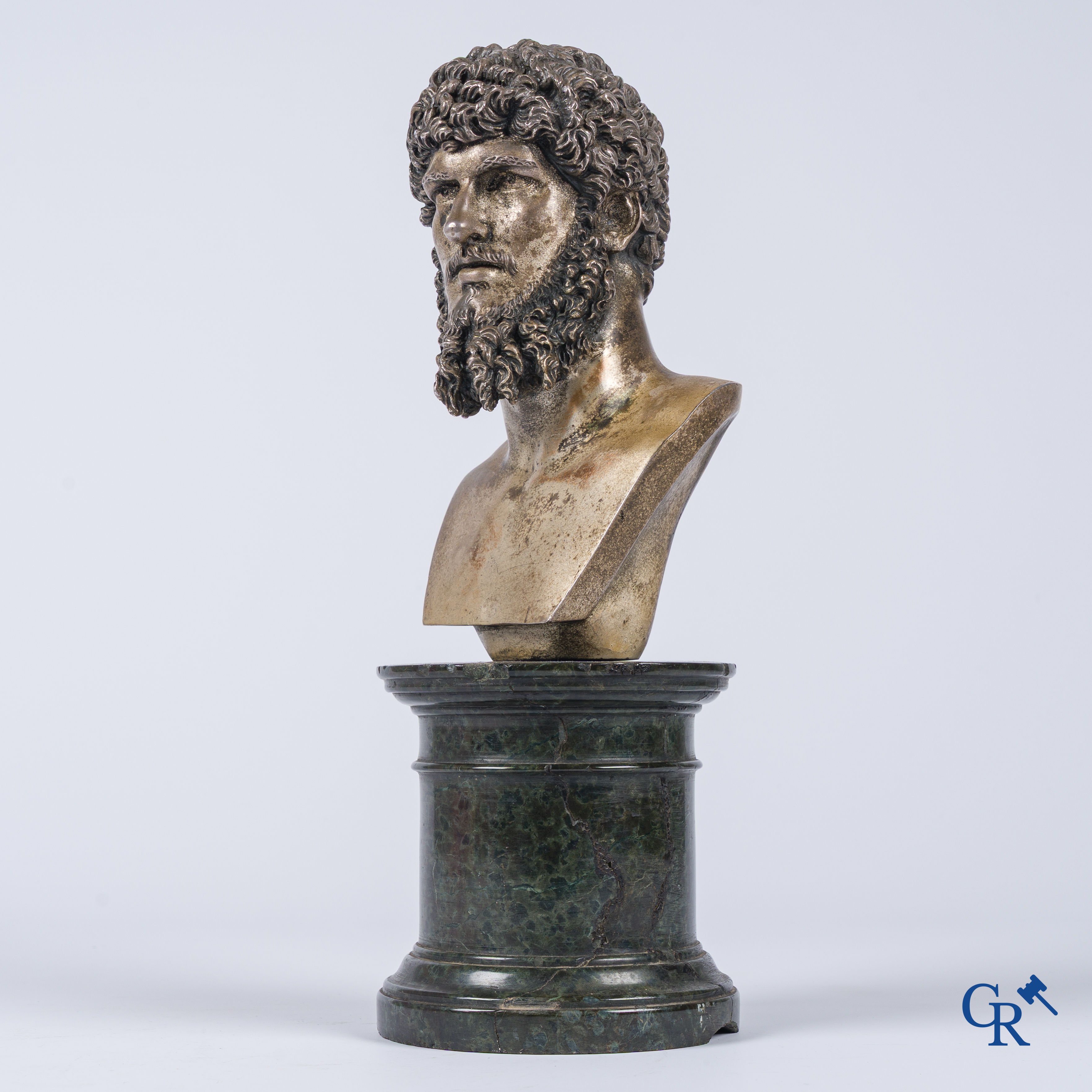A silvered bronze bust of Lucius Verus on a dark green serpentine pedestal. 19th century.