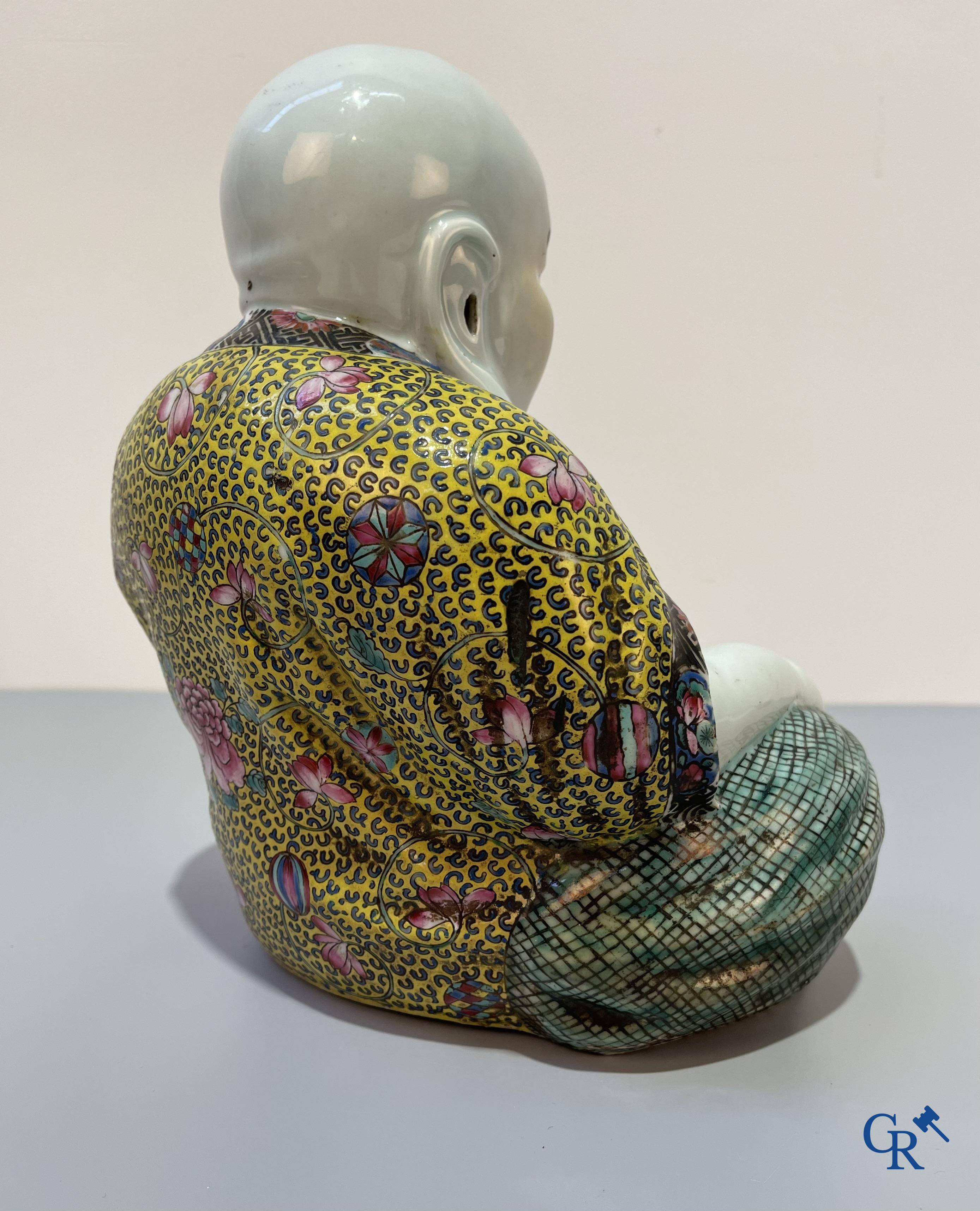 Asian Art, Chinese porcelain. A Chinese famille rose figure of a Buddha with a seal mark. 19th century.