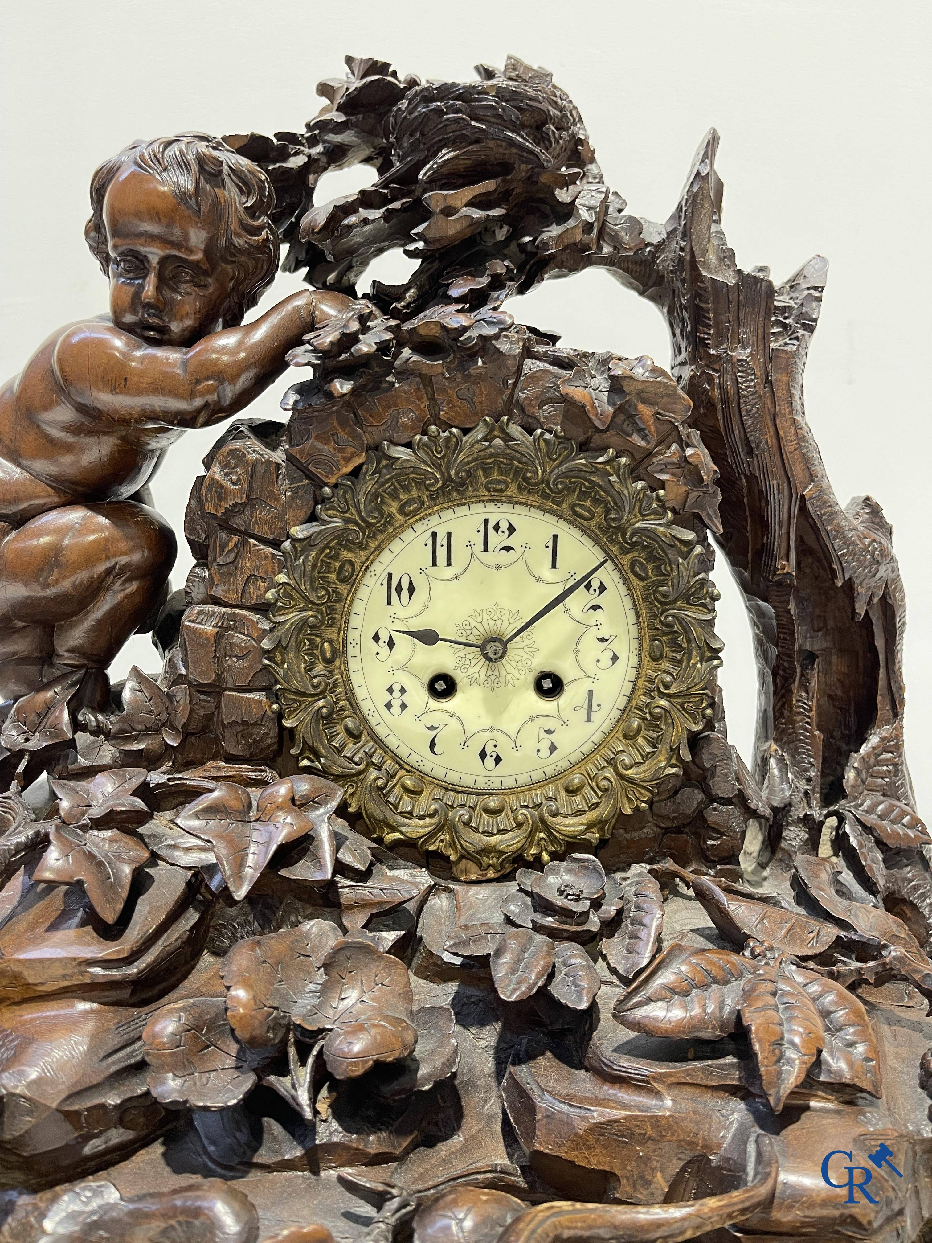 A finely carved walnut clock in so-called "black forest" carving. French work circa 1860-1880.