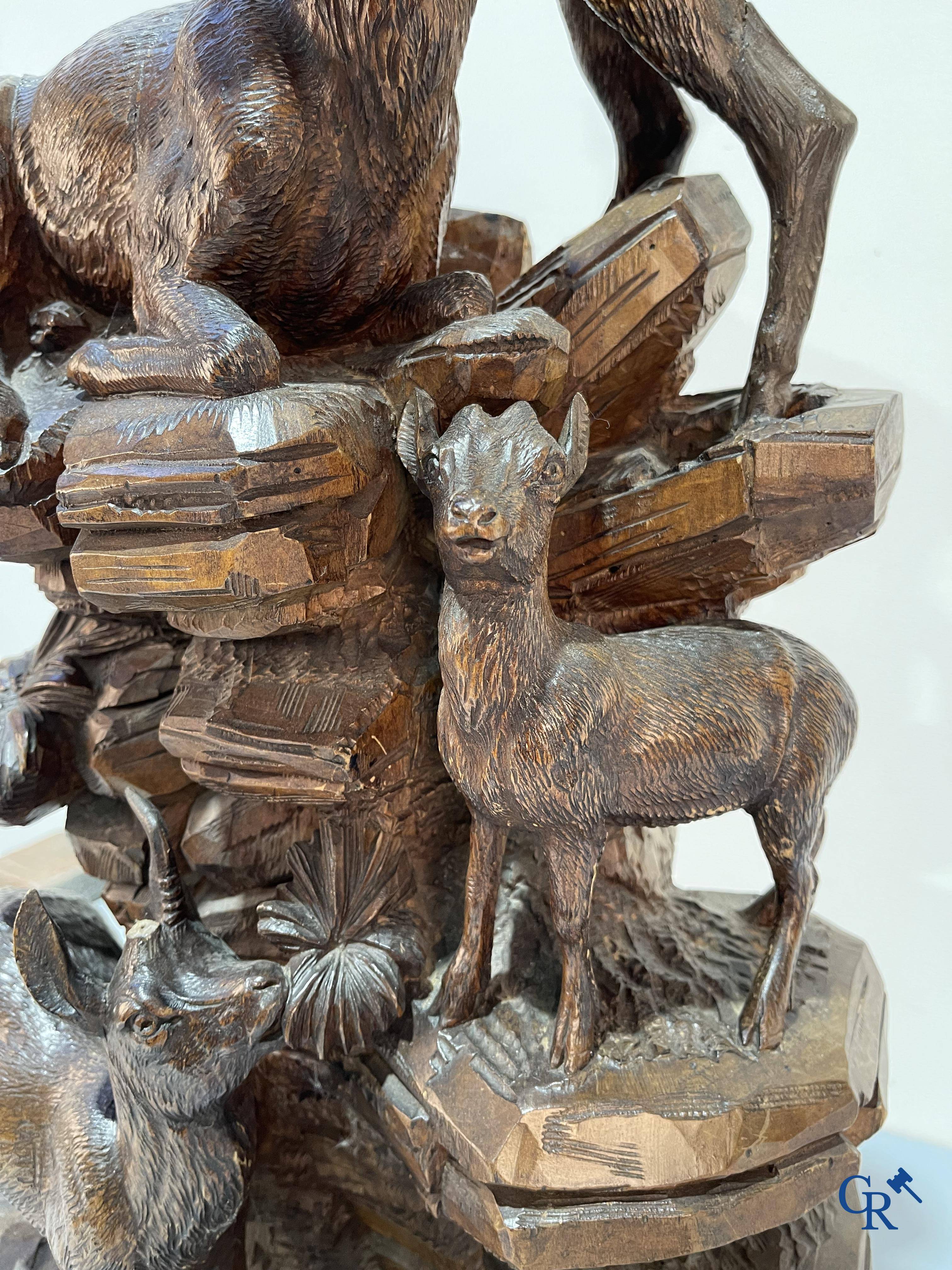 Imposing wood sculpture with chamois on a rocky mountain landscape in so-called "black forest". German work, late 19th century.
