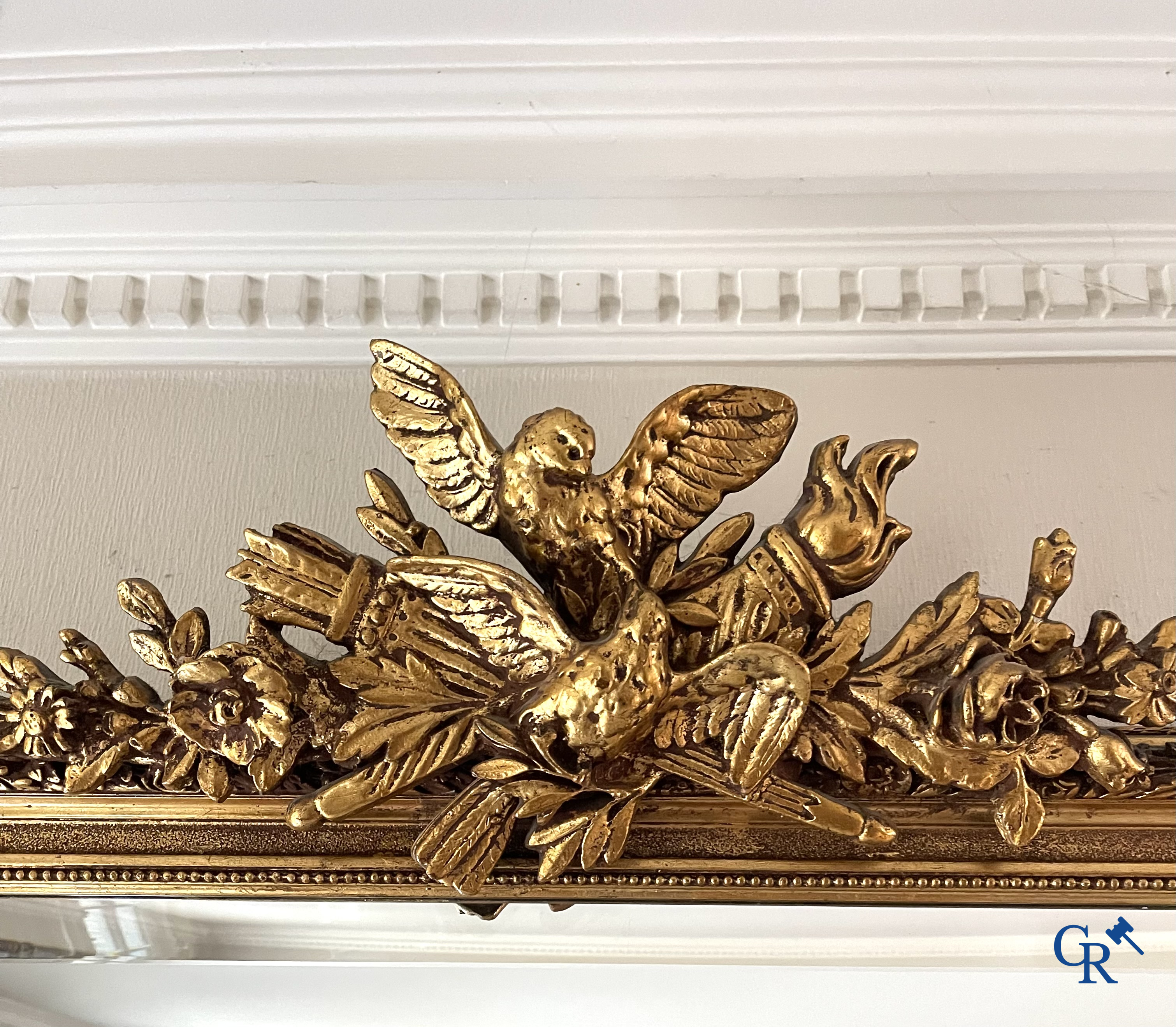 A large gilded fireplace mirror in LXVI style. Circa 1920.