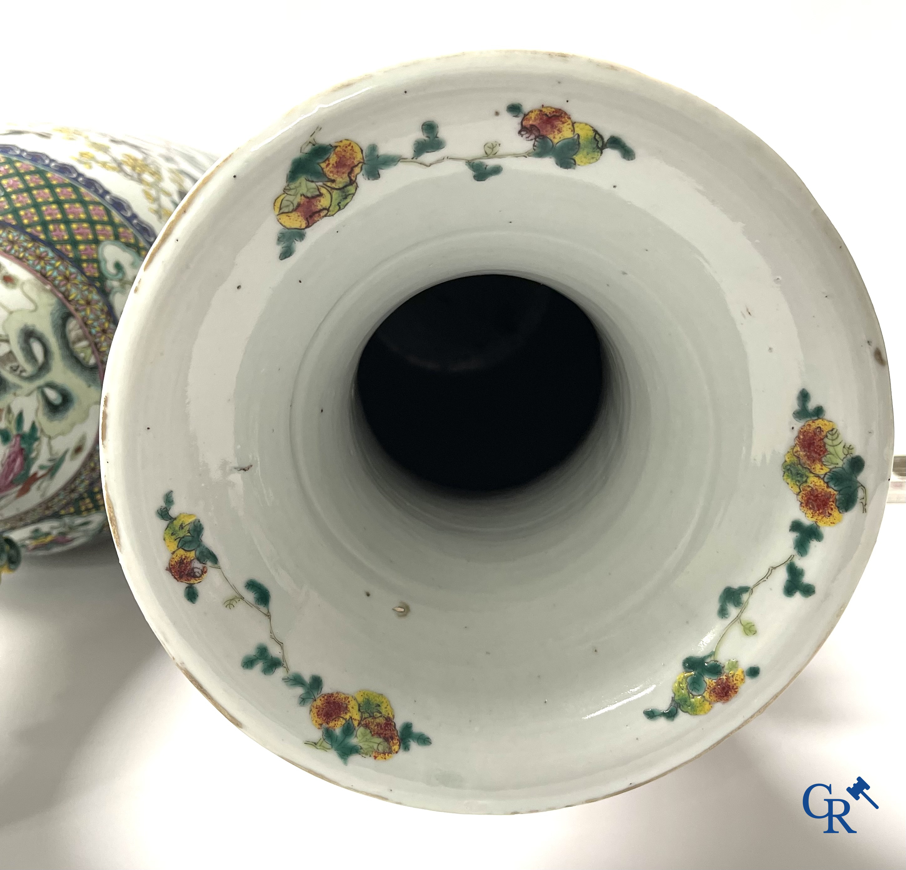 Asian Art, A pair of Chinese famille rose vases with peacocks and Fo dogs. 19th century.