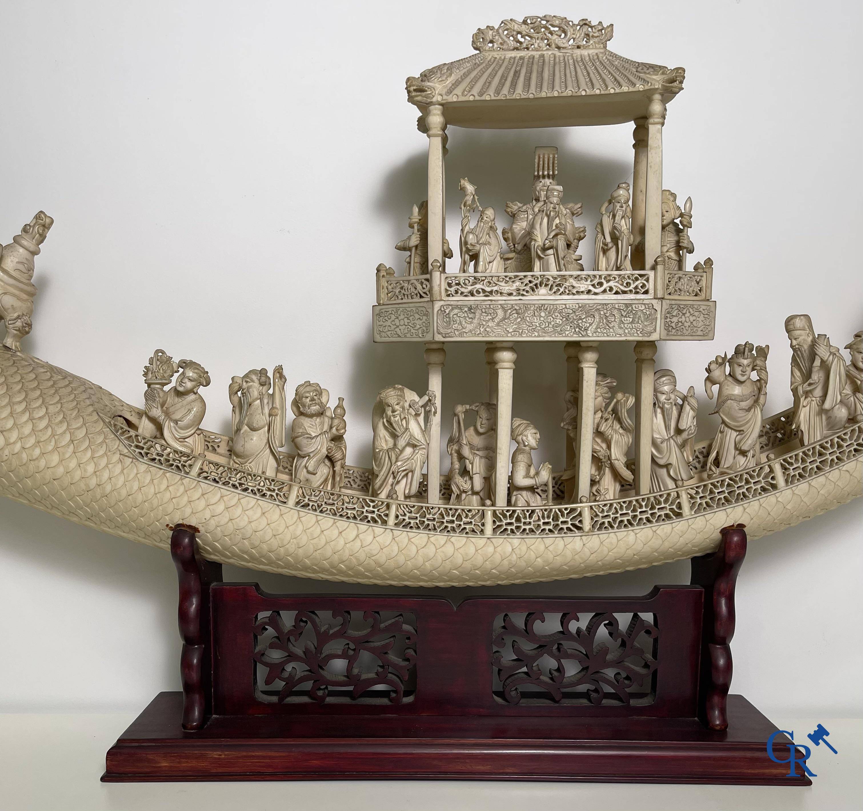 Asian Art: A large Chinese ivory dragon boat on a wooden pedestal. 19th century.