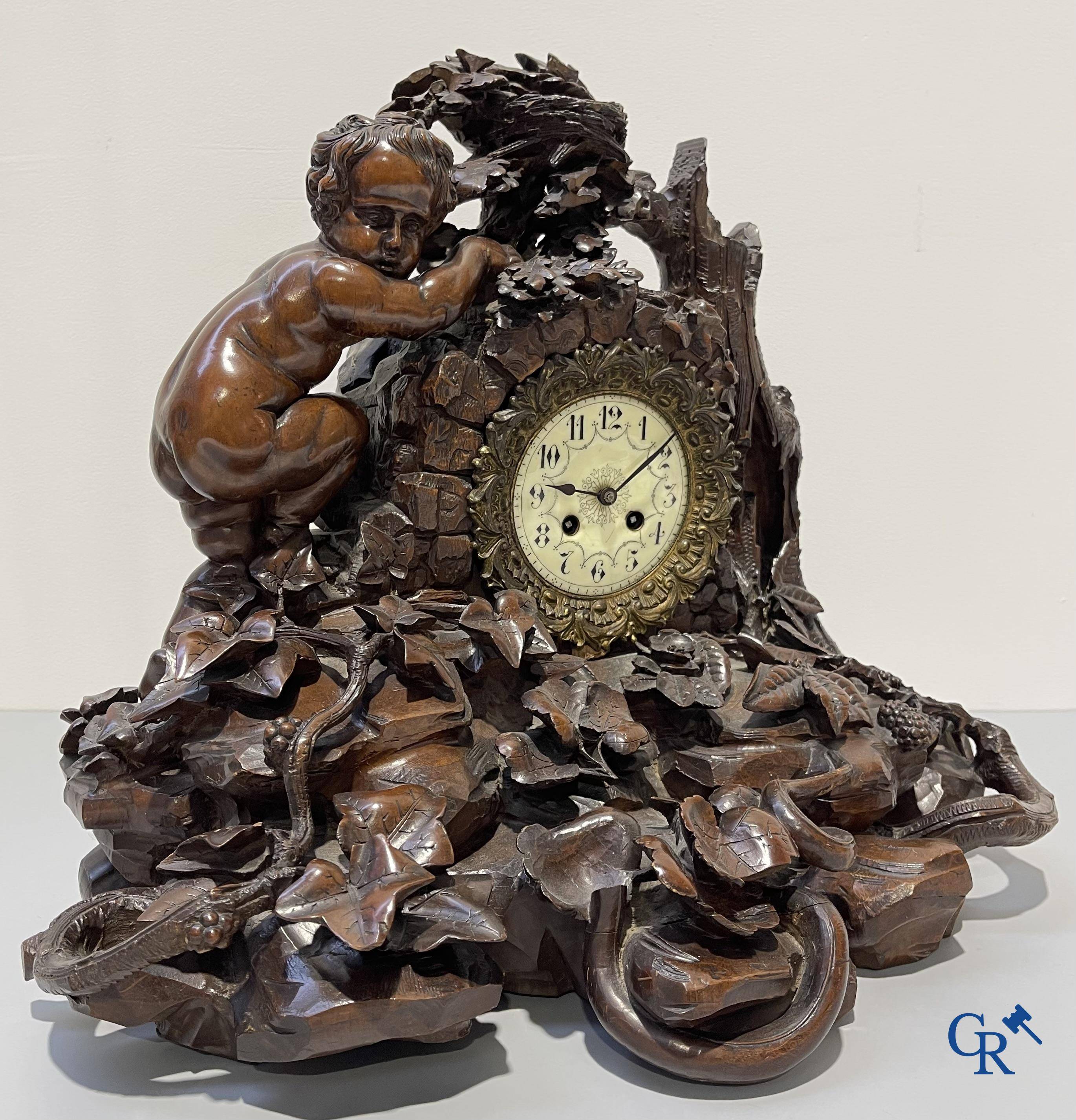 A finely carved walnut clock in so-called "black forest" carving. French work circa 1860-1880.