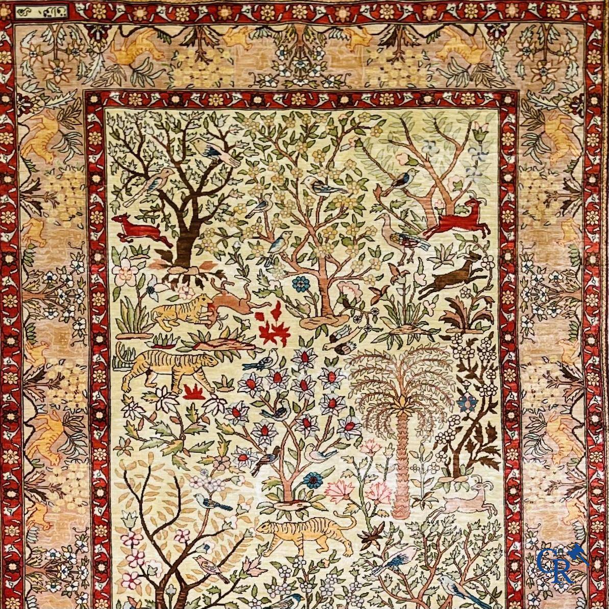 Oriental rugs, a fine hand-knotted silk tapestry with animals in a forest. Signed.