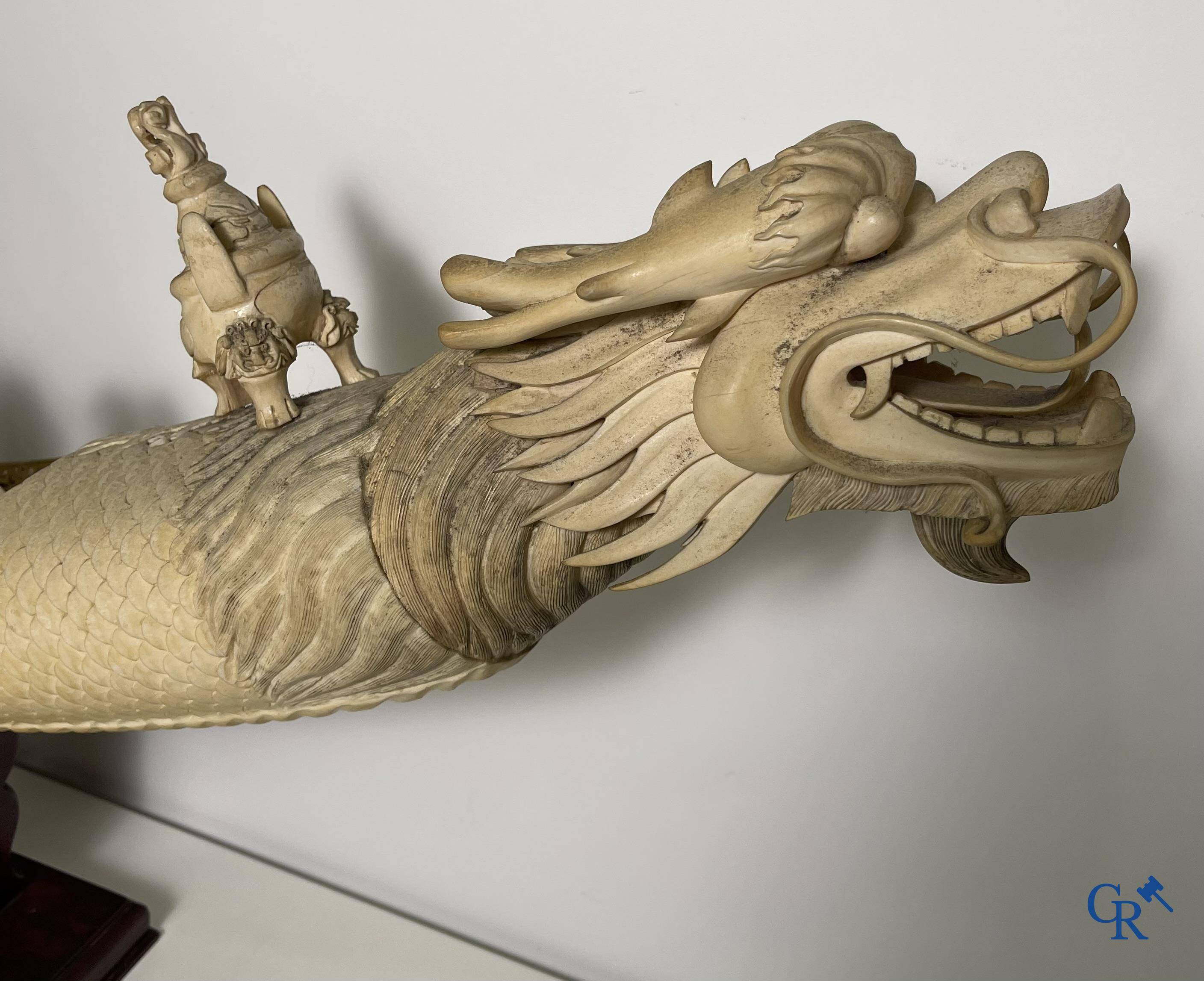Asian Art: A large Chinese ivory dragon boat on a wooden pedestal. 19th century.