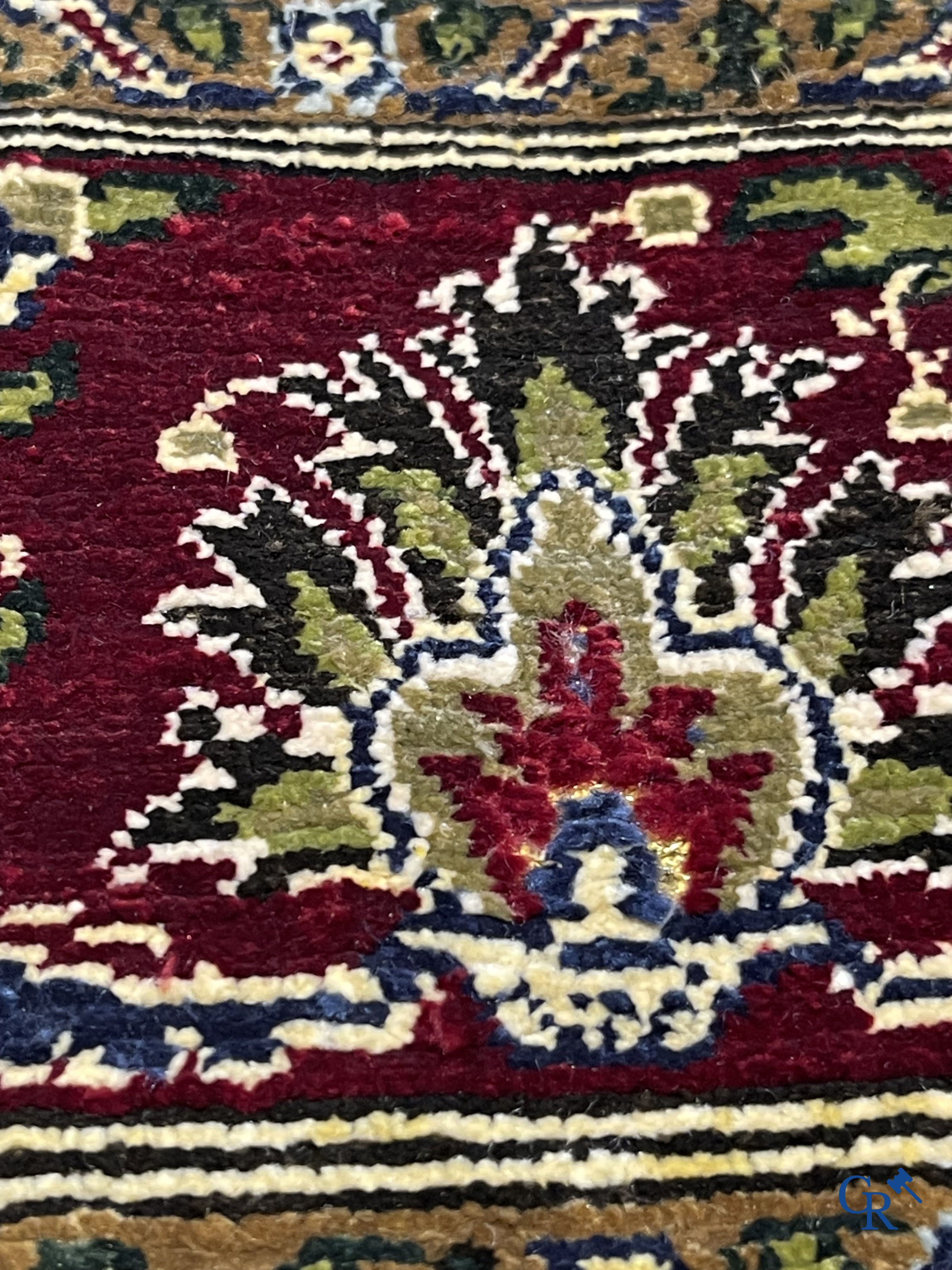 Oosterse tapijten. Een uiterst fijn geknoopt zijden tapijt met floraal decor op donker blauwe achtergrond en gouddraad.