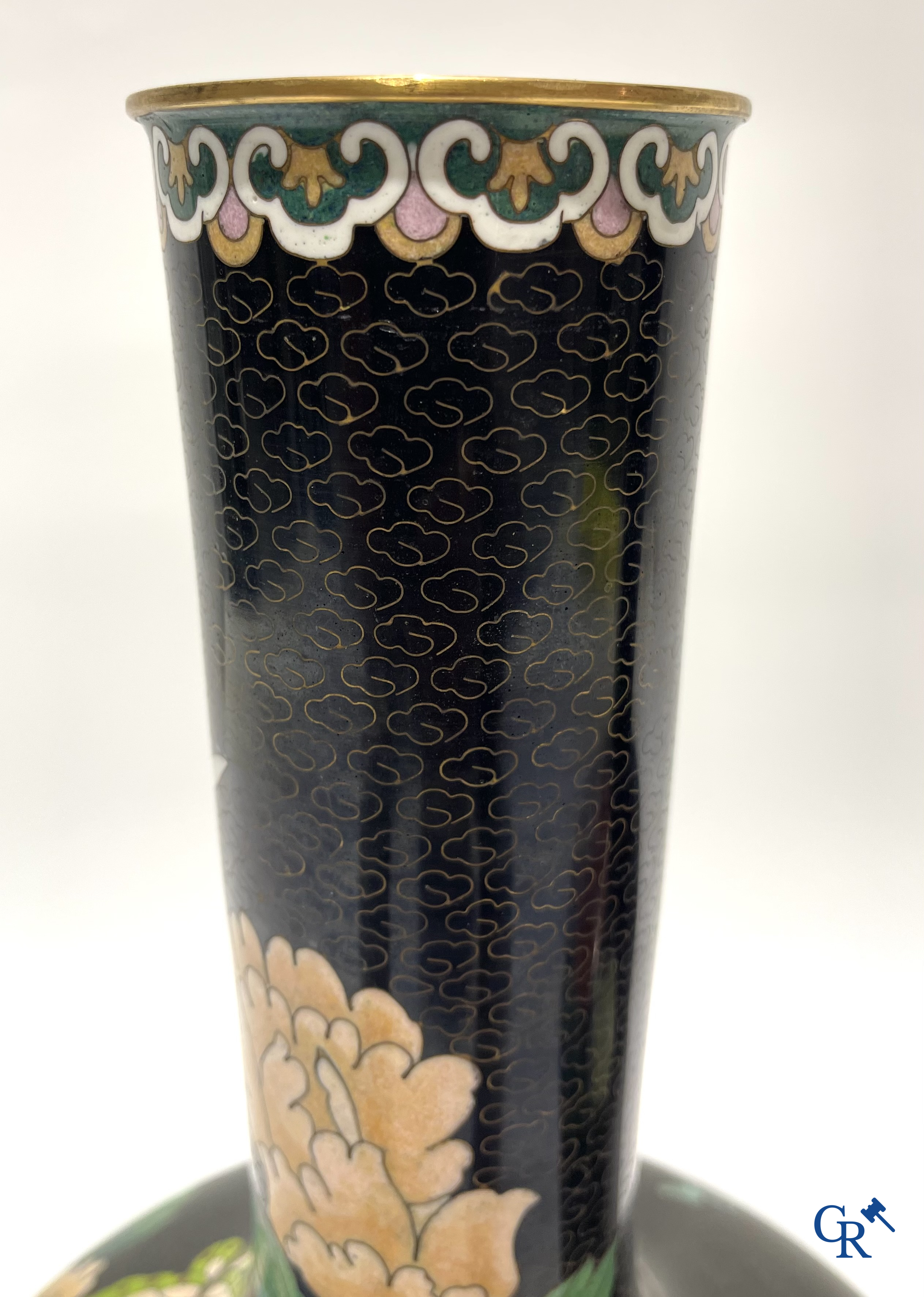A pair of Chinese cloisonne vases with floral decor.