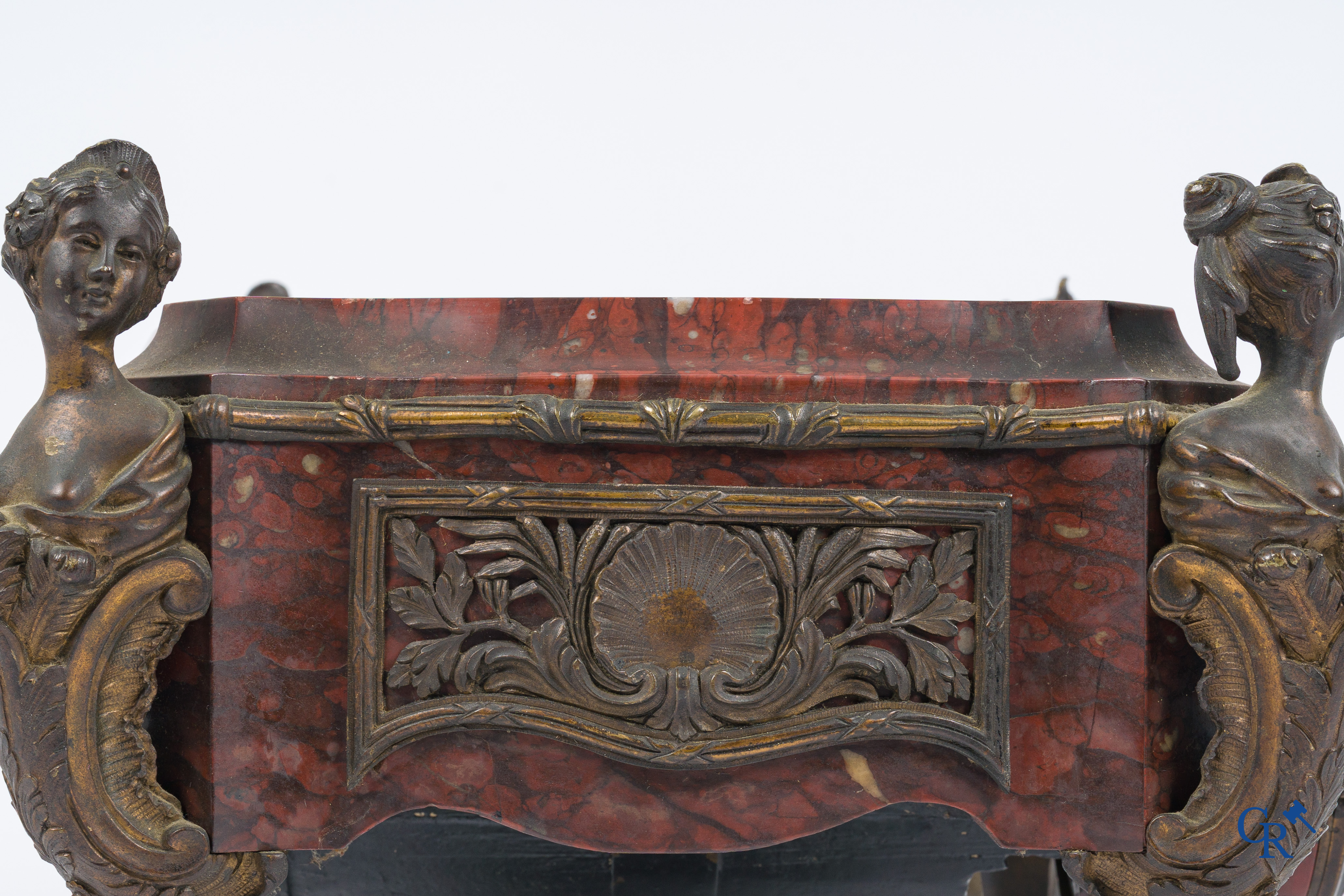 Napoleon III. A pedestal in marble and finely chiseled bronze with an incorporated clock. France, circa 1880.