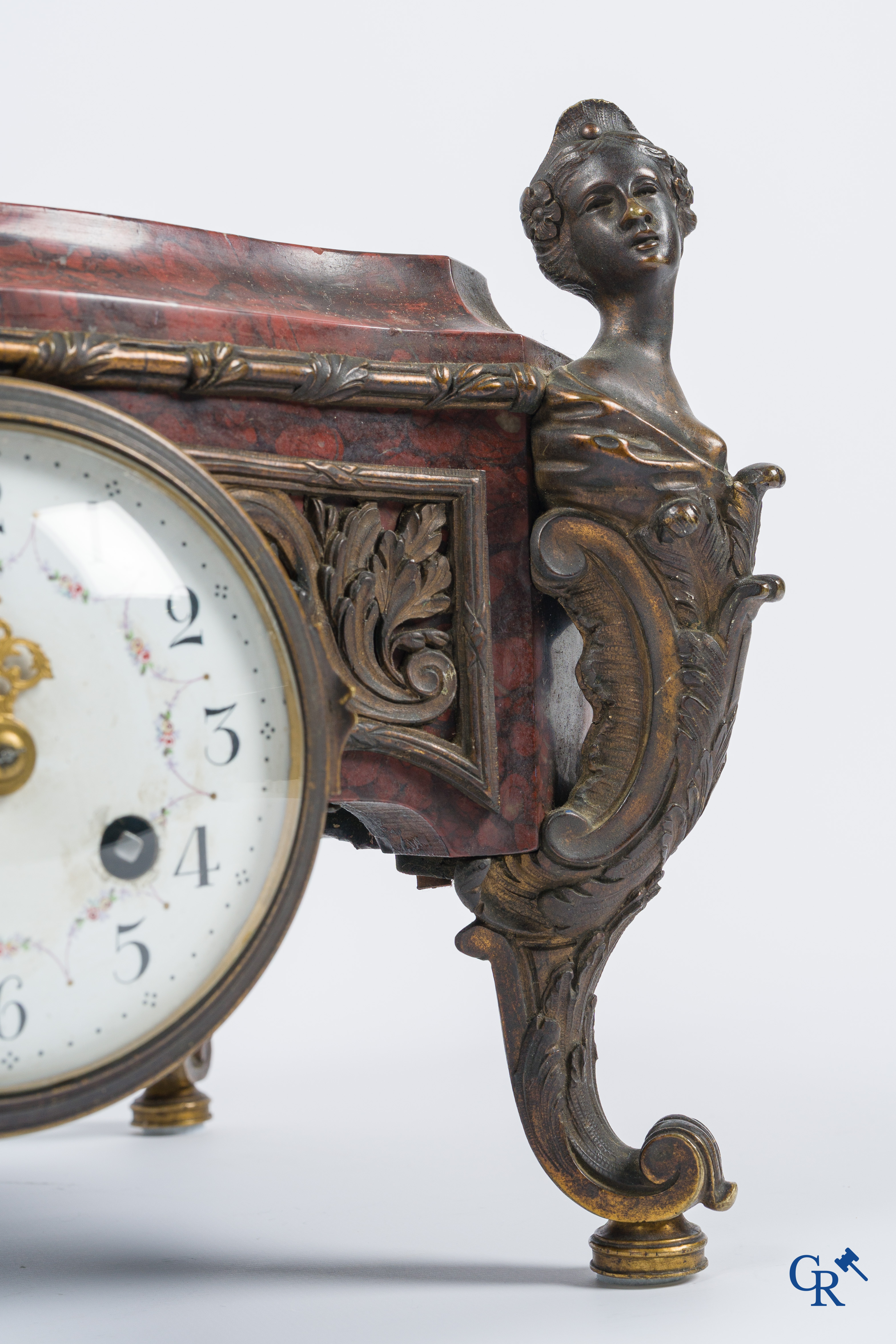 Napoleon III. A pedestal in marble and finely chiseled bronze with an incorporated clock. France, circa 1880.