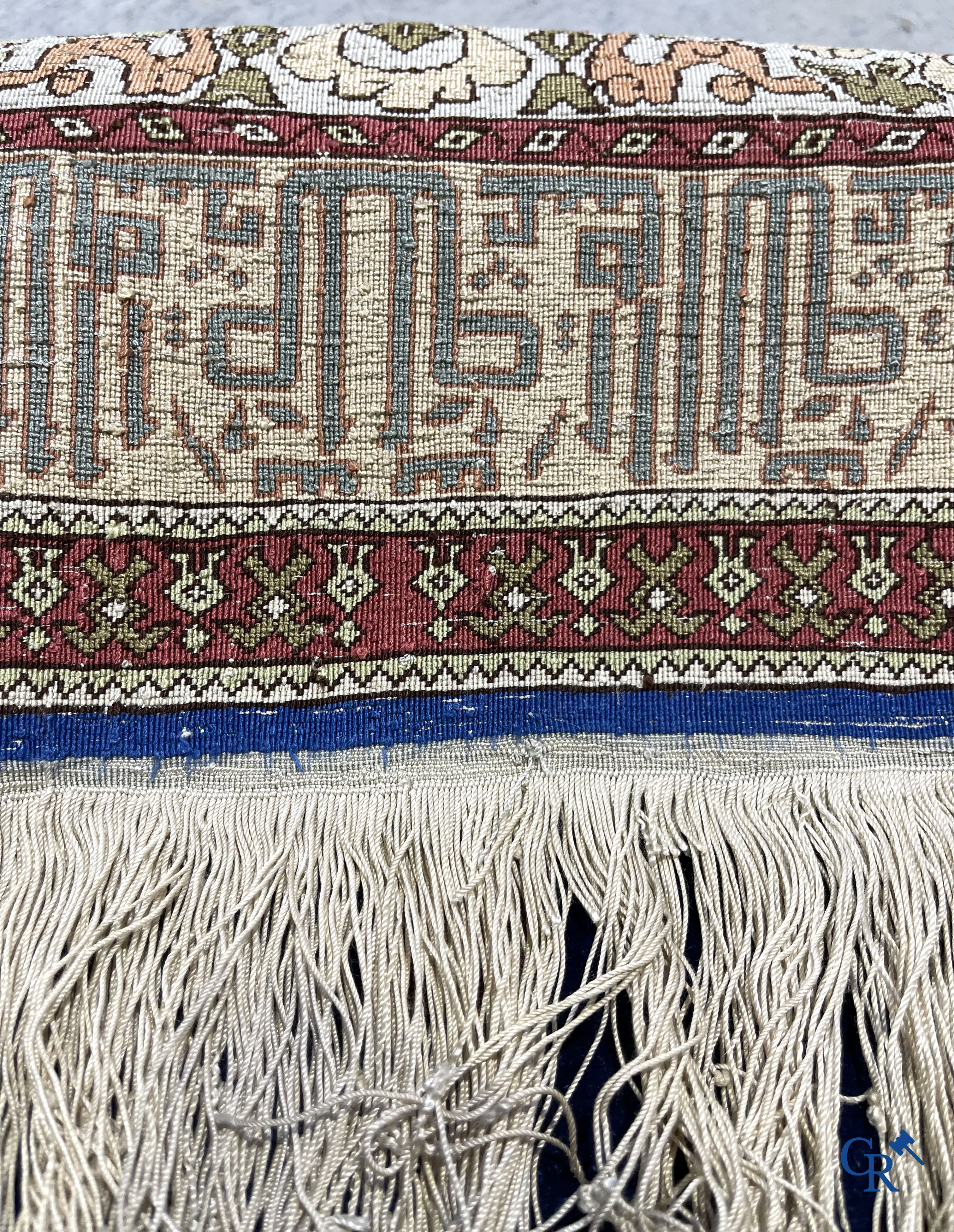 Oriental carpets. Extremely finely hand knotted silk carpet with inscriptions and gold thread. Signed.