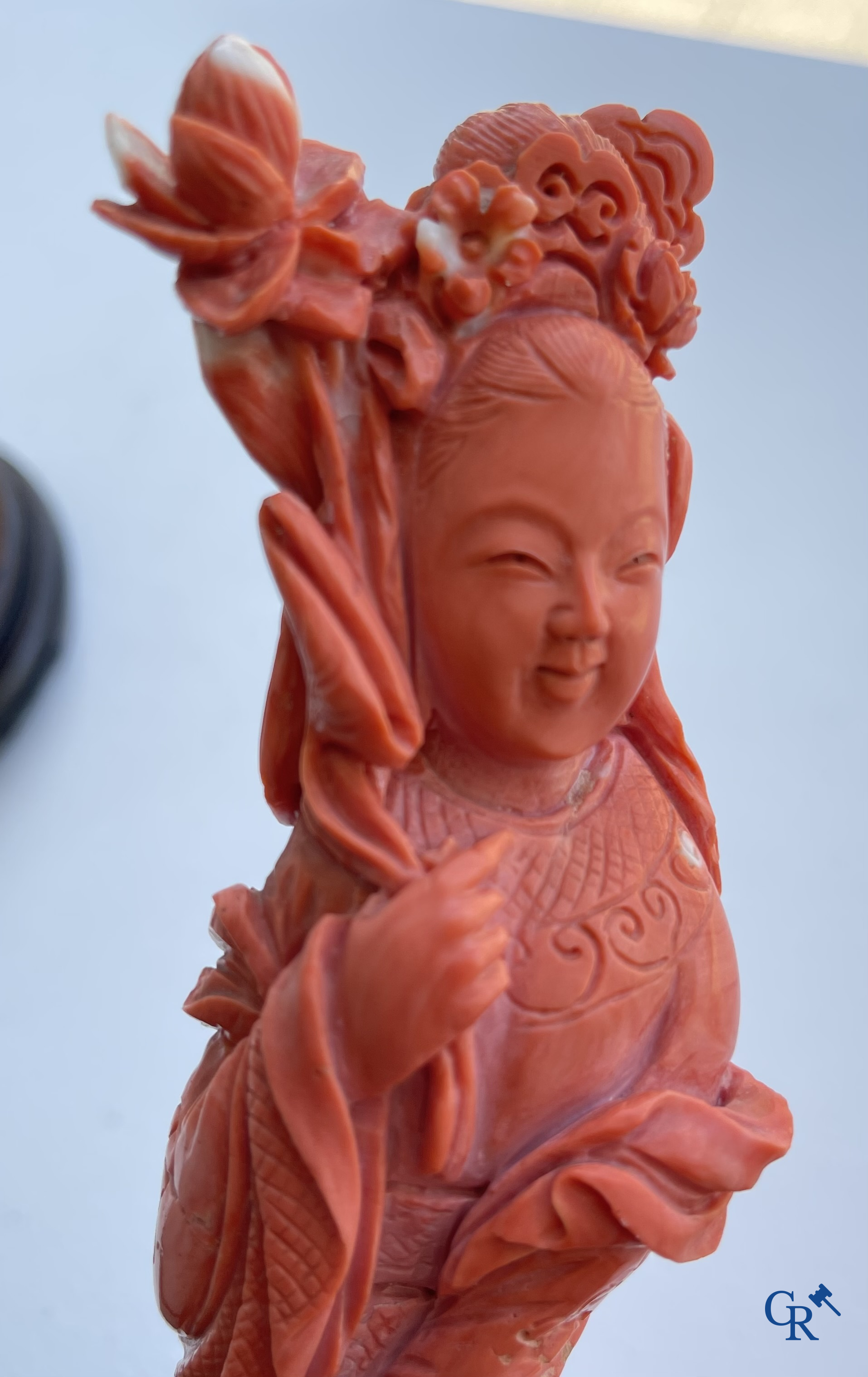 Asian Art, China. A red coral figure of a Chinese lady on a wooden pedestal.