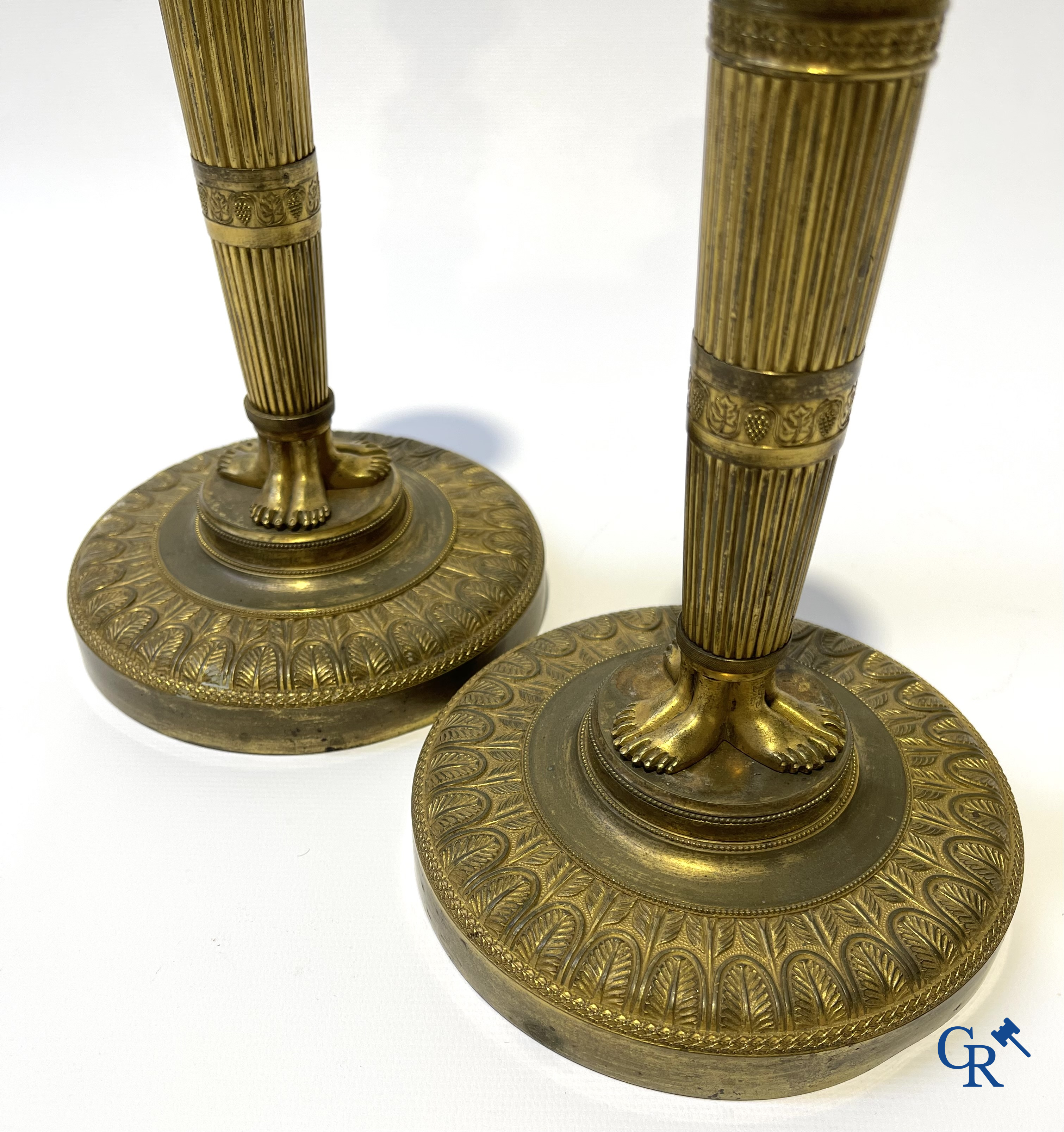 Empire. A pair of early 19th century bronze gilded candlesticks with caryatides. French work.