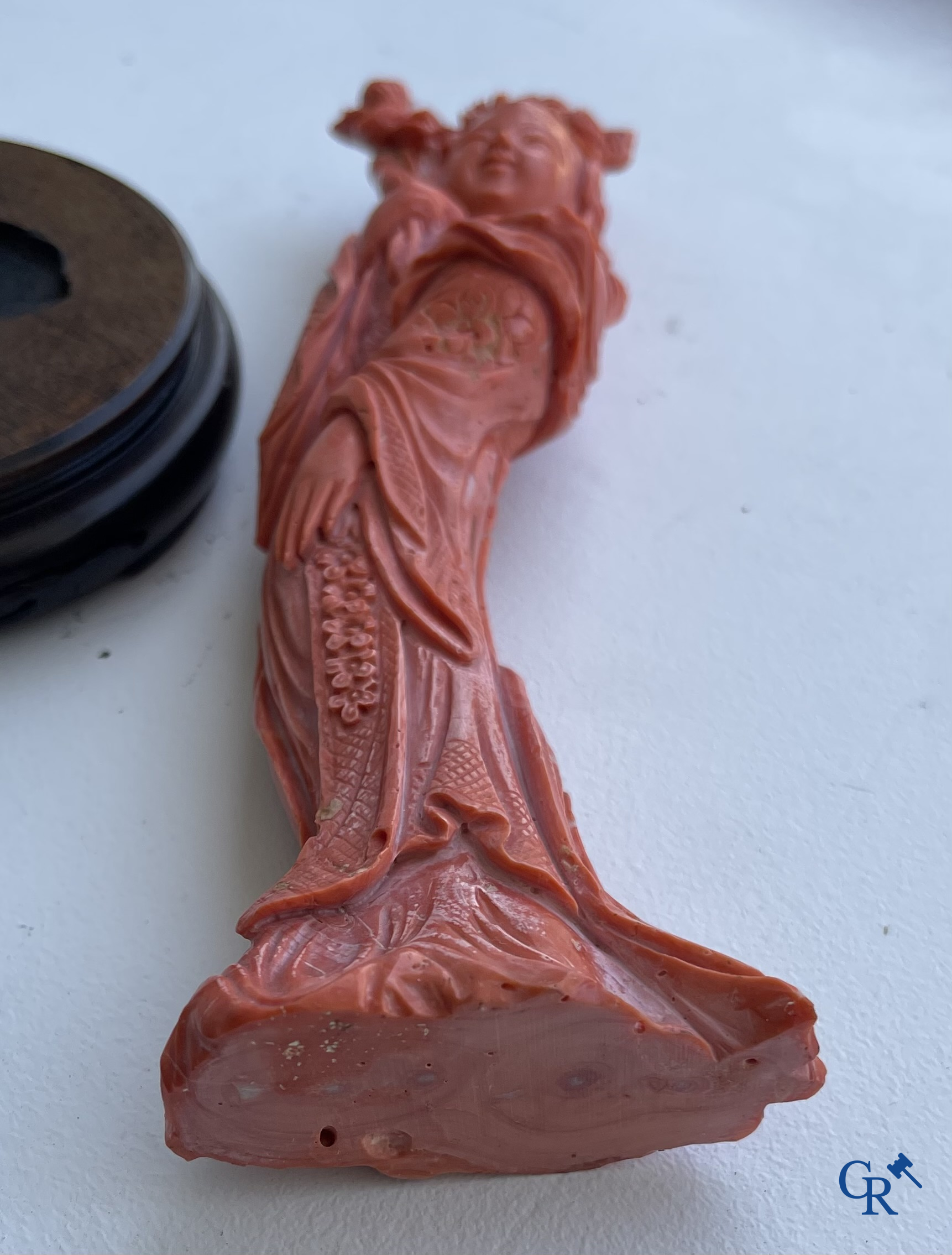 Asian Art, China. A red coral figure of a Chinese lady on a wooden pedestal.