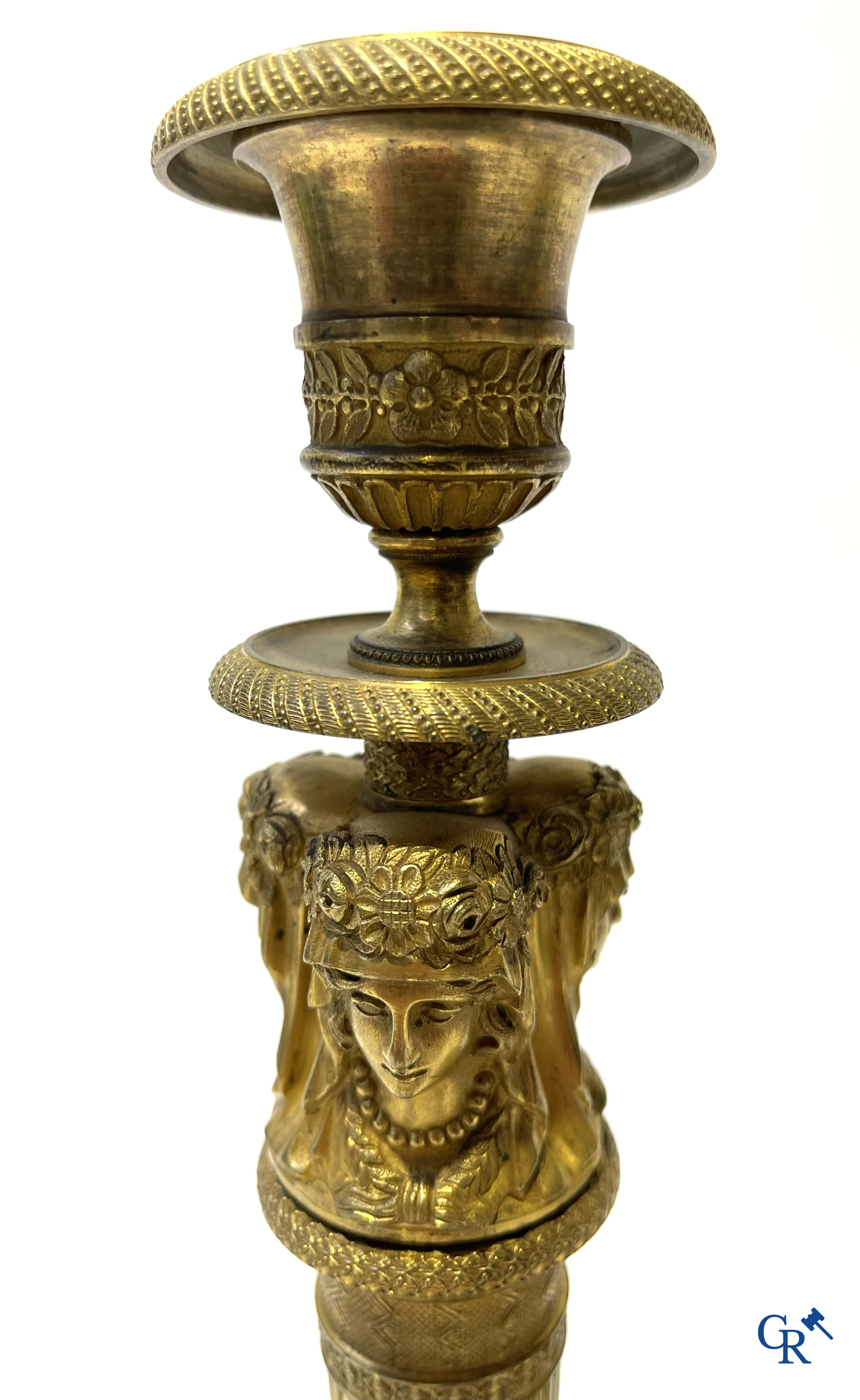 Empire. A pair of early 19th century bronze gilded candlesticks with caryatides. French work.