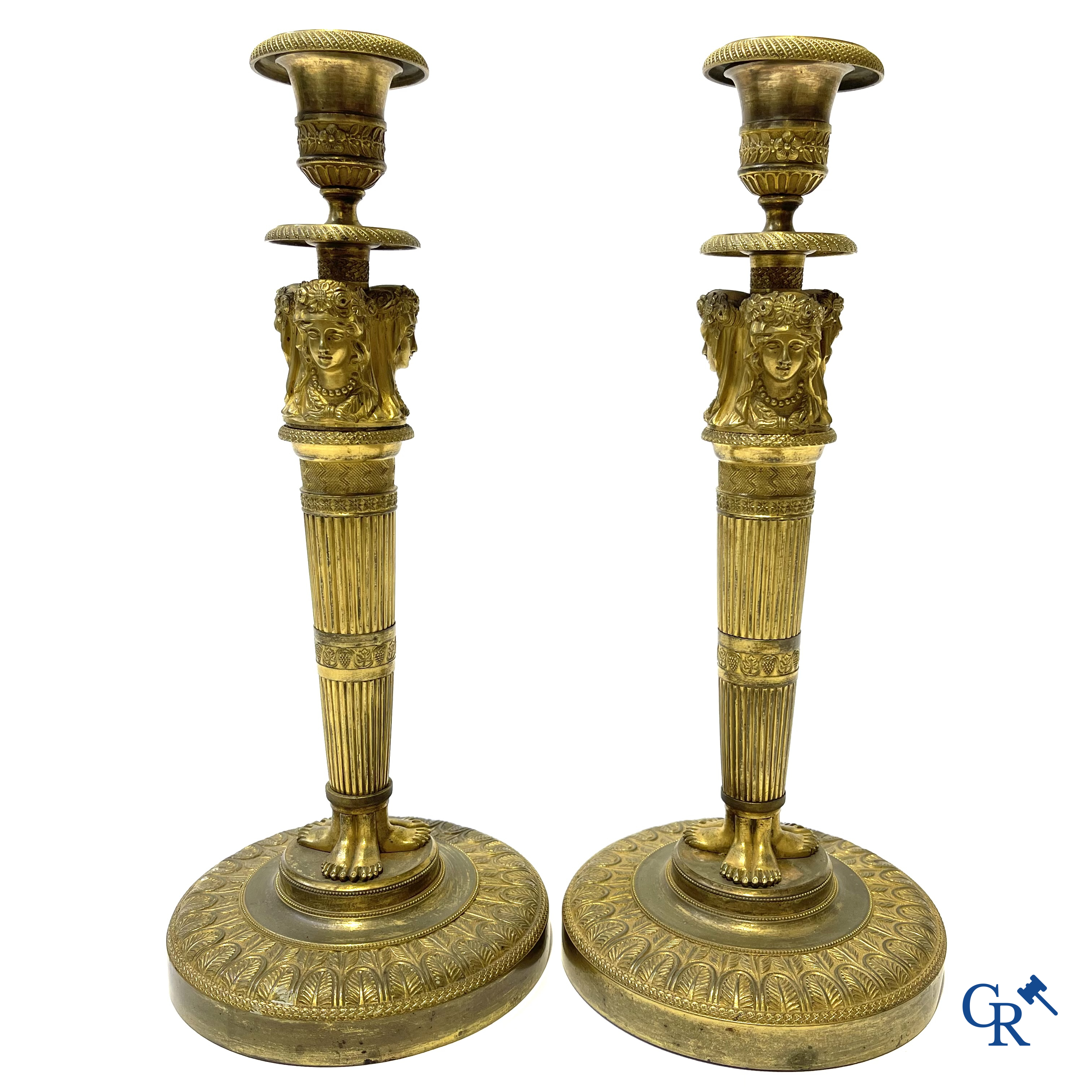 Empire. A pair of early 19th century bronze gilded candlesticks with caryatides. French work.