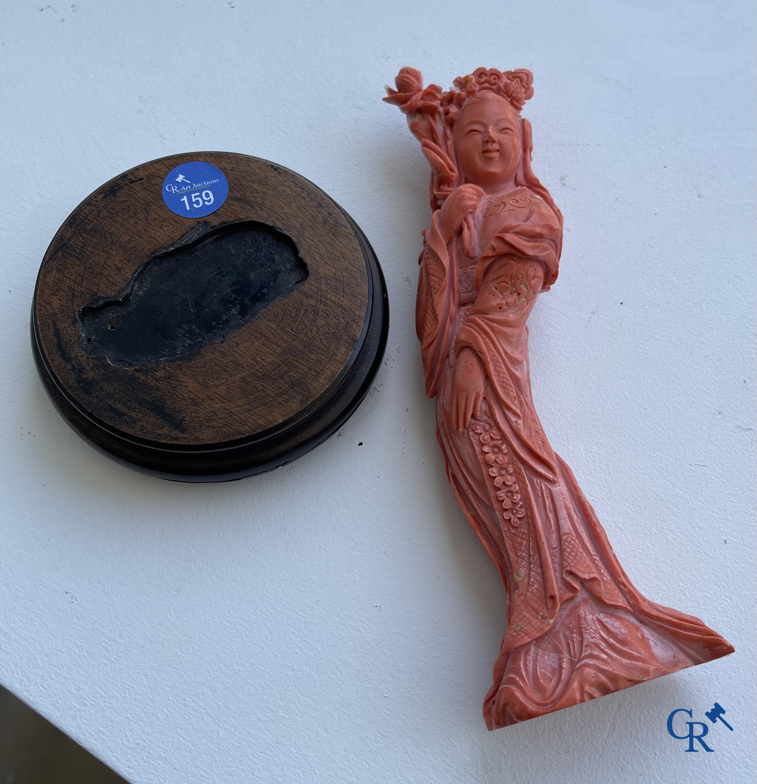 Asian Art, China. A red coral figure of a Chinese lady on a wooden pedestal.