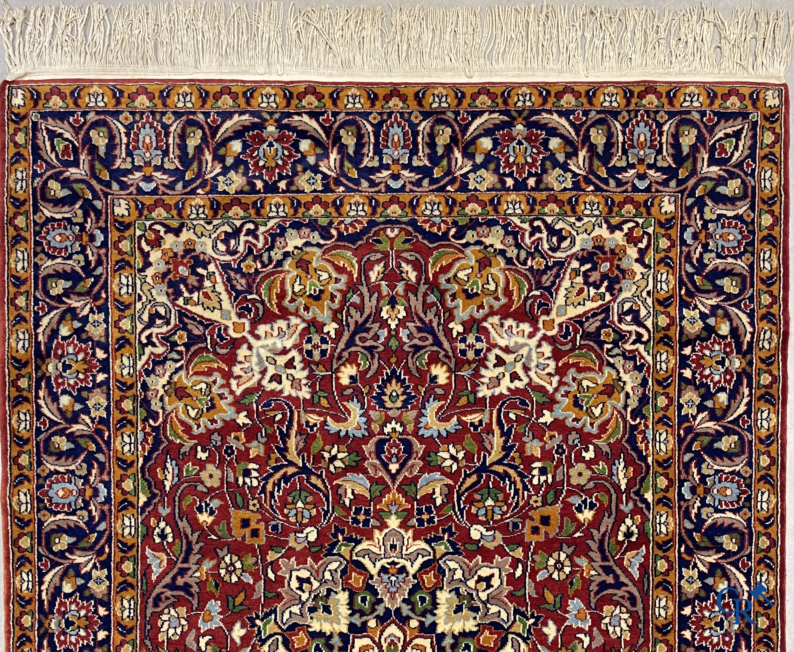 Oriental carpets. Finely hand-knotted carpet with floral decor on a dark red background.