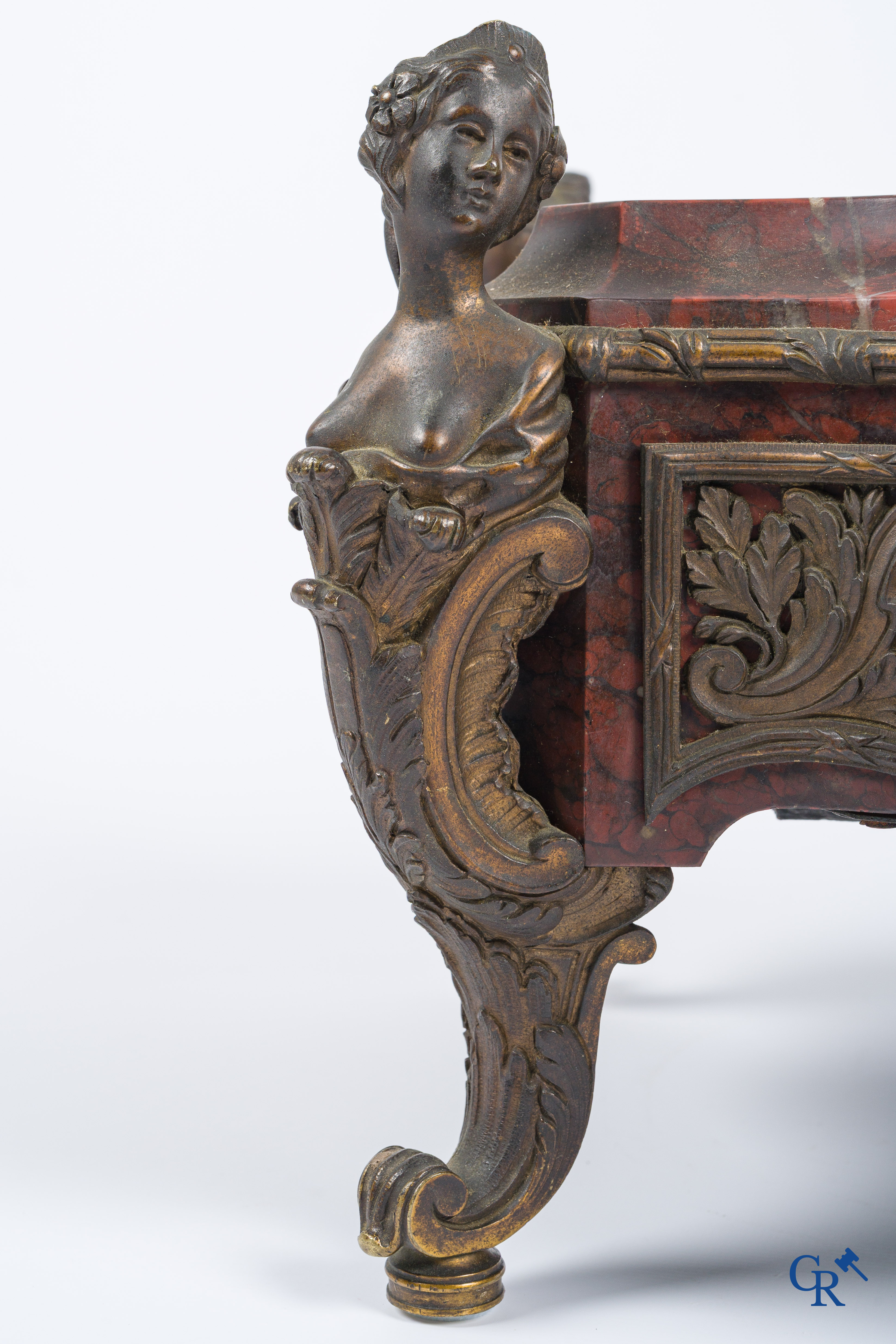 Napoleon III. A pedestal in marble and finely chiseled bronze with an incorporated clock. France, circa 1880.