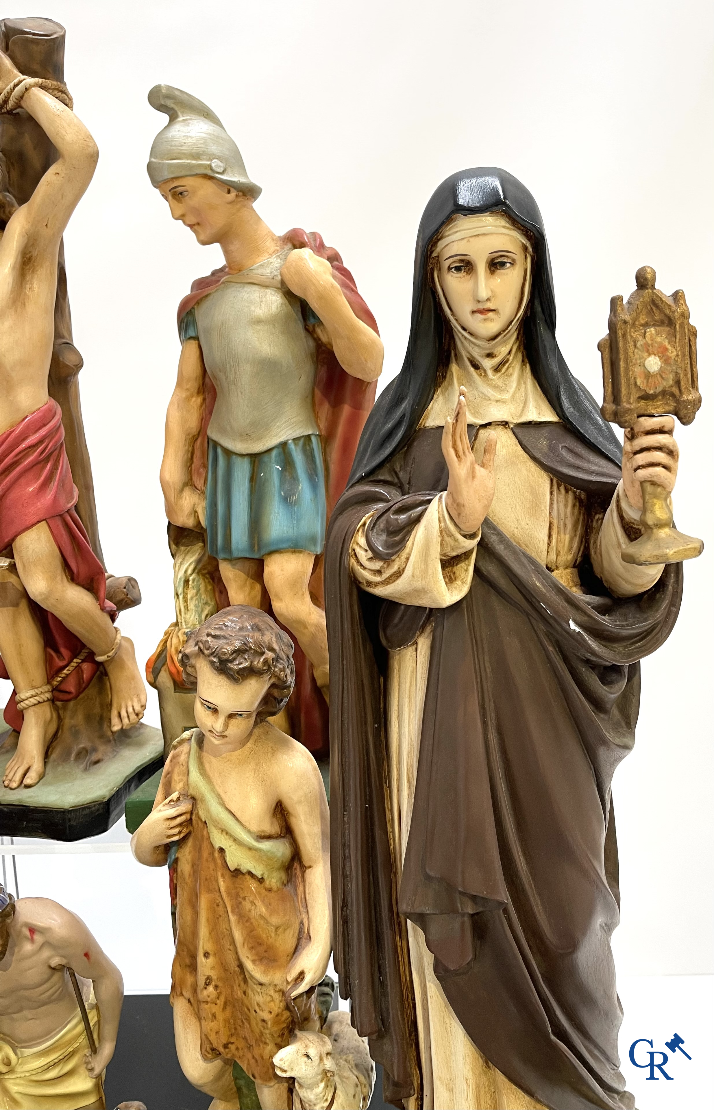 Religious objects. Large lot of various statues of saints in plaster.