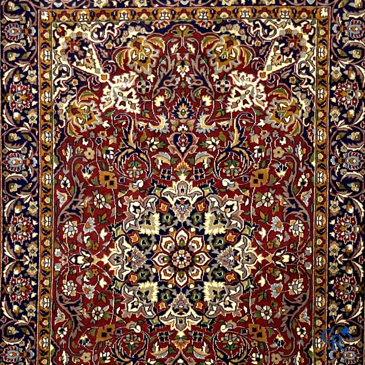 Oriental carpets. Finely hand-knotted carpet with floral decor on a dark red background.