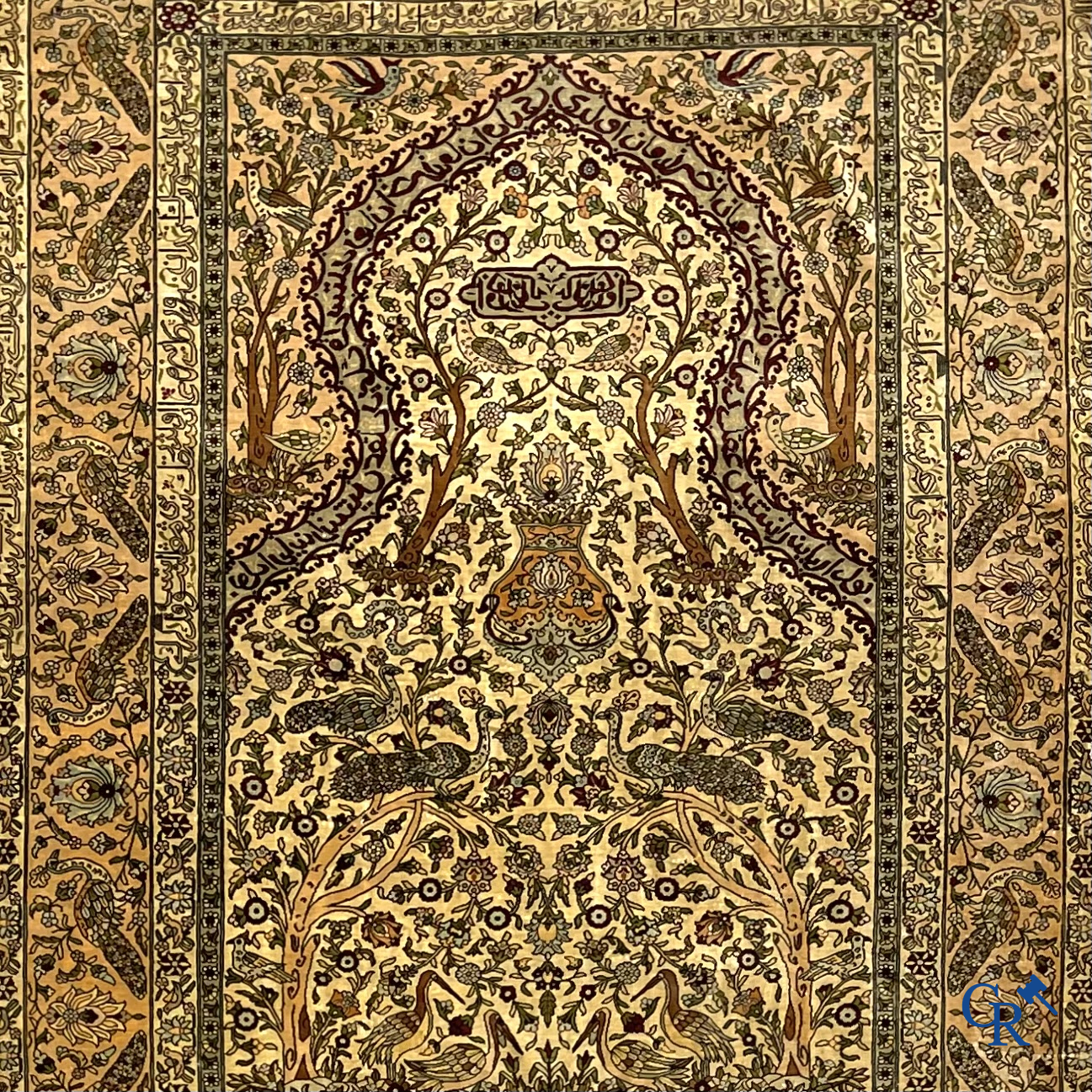 Oriental carpets. Hereke. A finely hand-knotted silk carpet with birds in the forest. Inscriptions and signed.