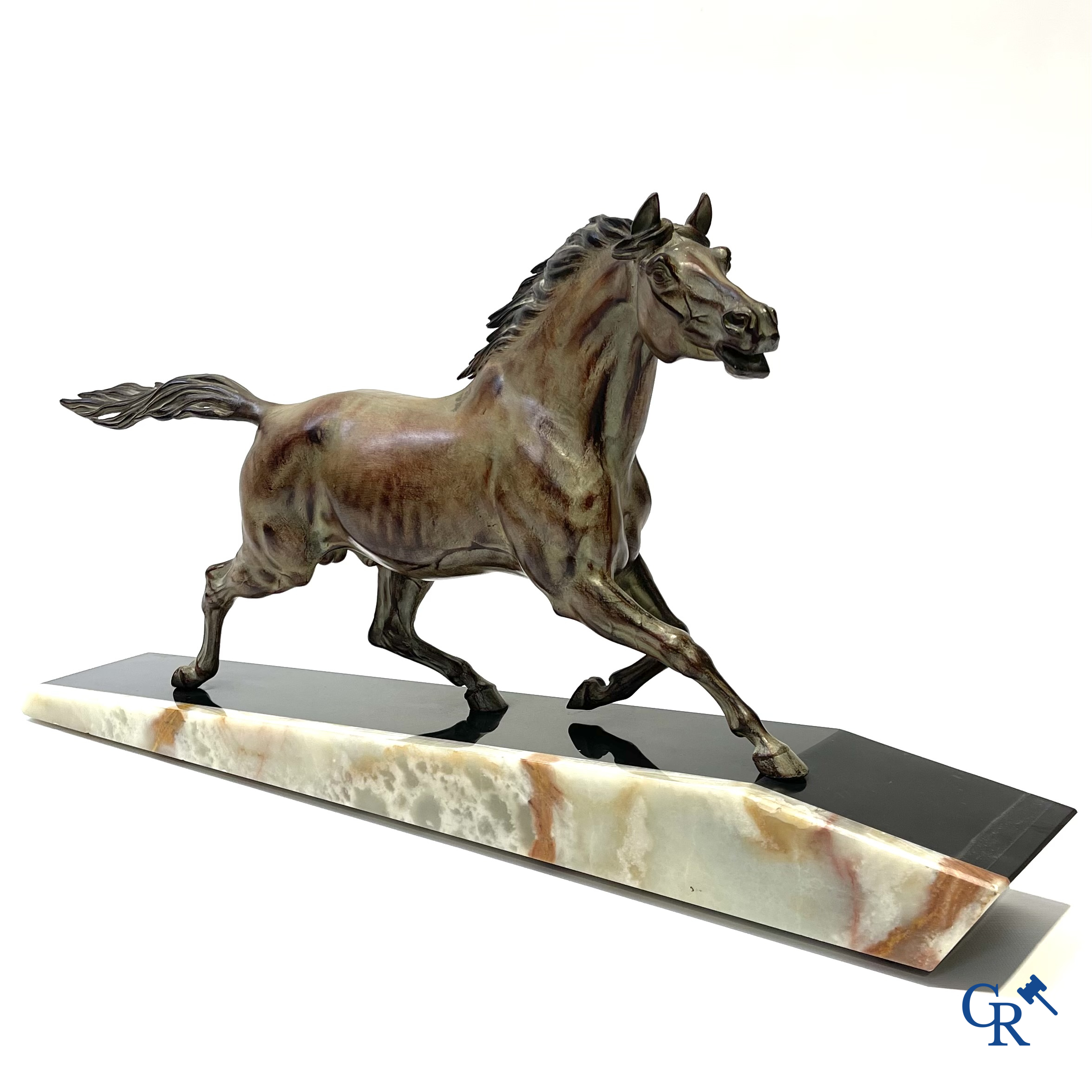 Voorstelling van een lopend paard op een sokkel in zwarte marmer en onyx. Gesigneerd Jonce.