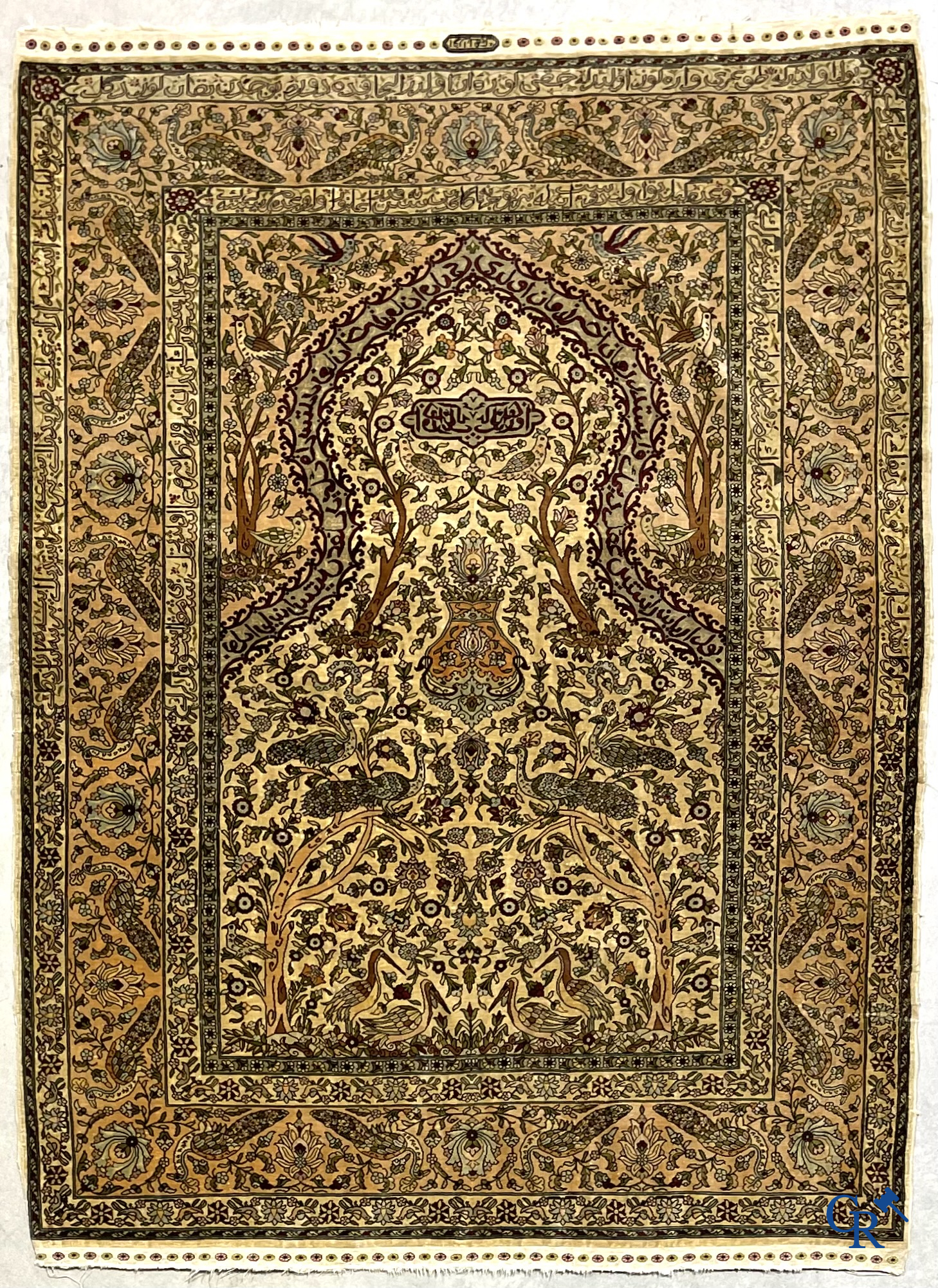 Oriental carpets. Hereke. A finely hand-knotted silk carpet with birds in the forest. Inscriptions and signed.