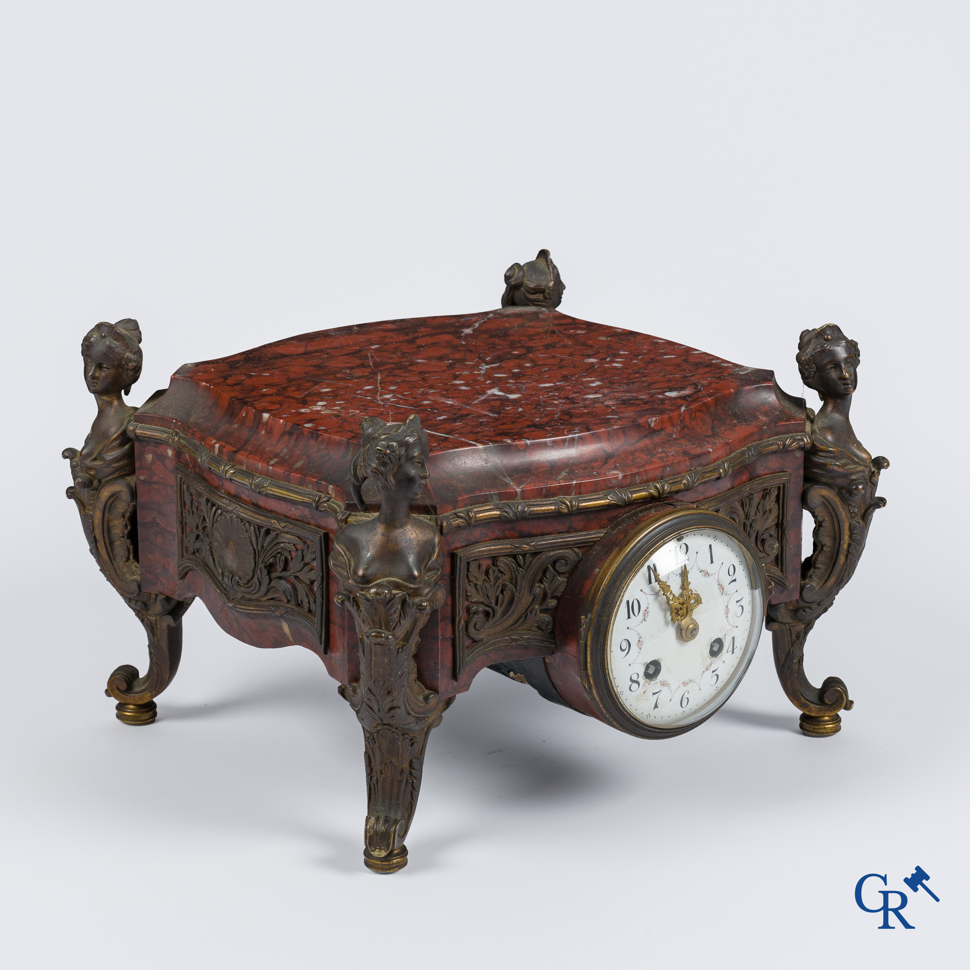 Napoleon III. A pedestal in marble and finely chiseled bronze with an incorporated clock. France, circa 1880.