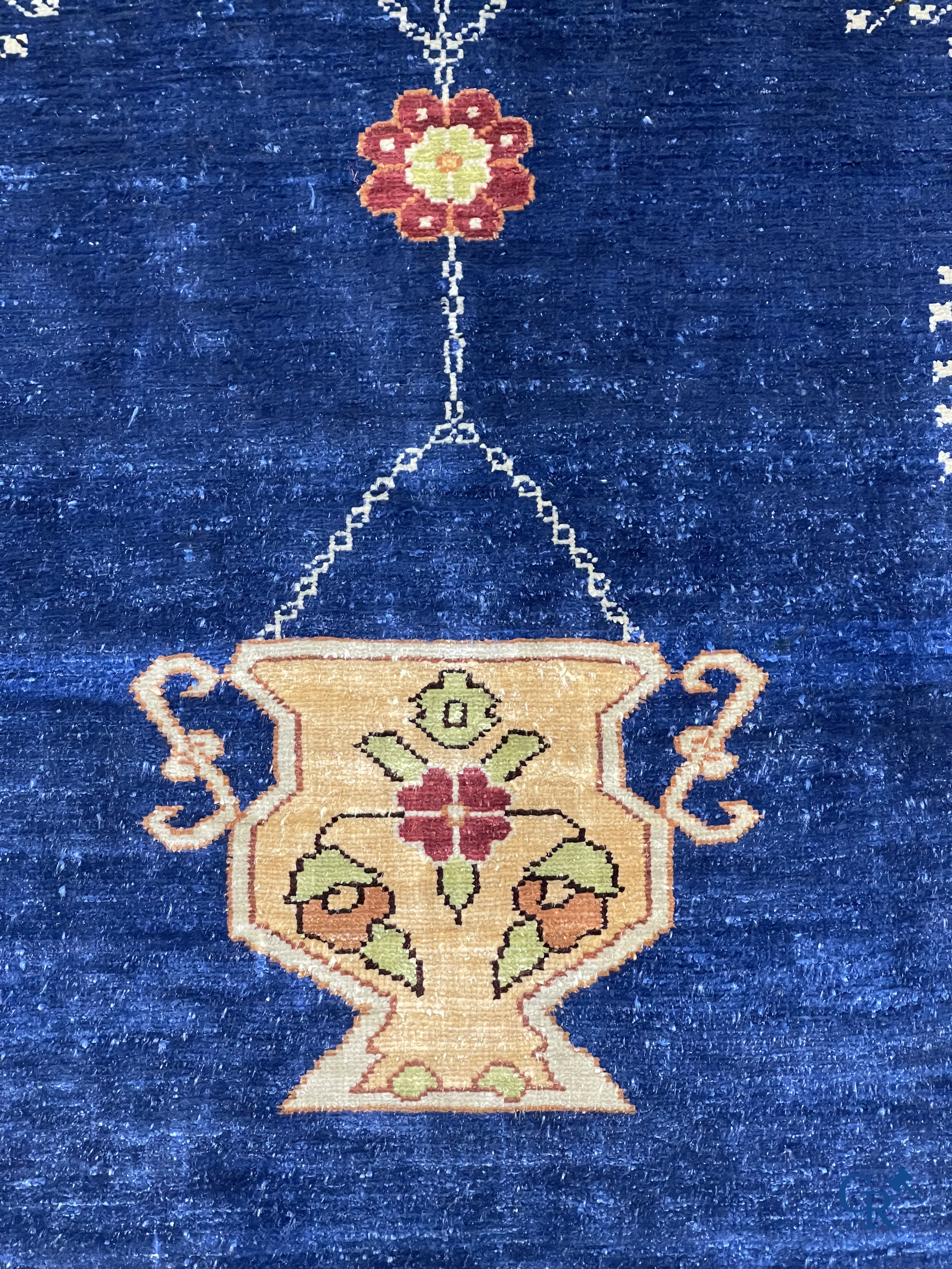 Oriental carpets. Extremely finely hand knotted silk carpet with inscriptions and gold thread. Signed.