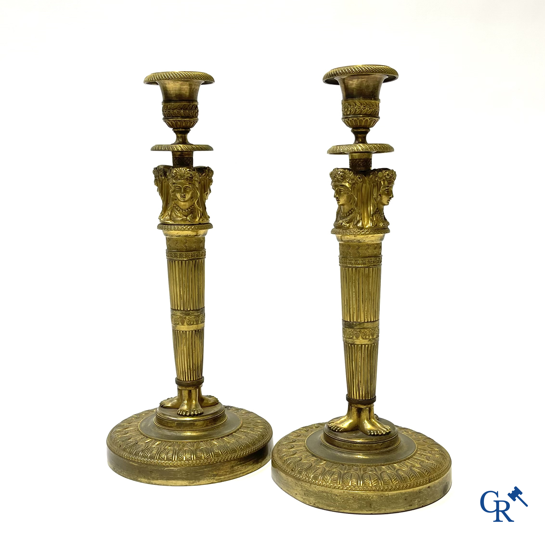 Empire. A pair of early 19th century bronze gilded candlesticks with caryatides. French work.