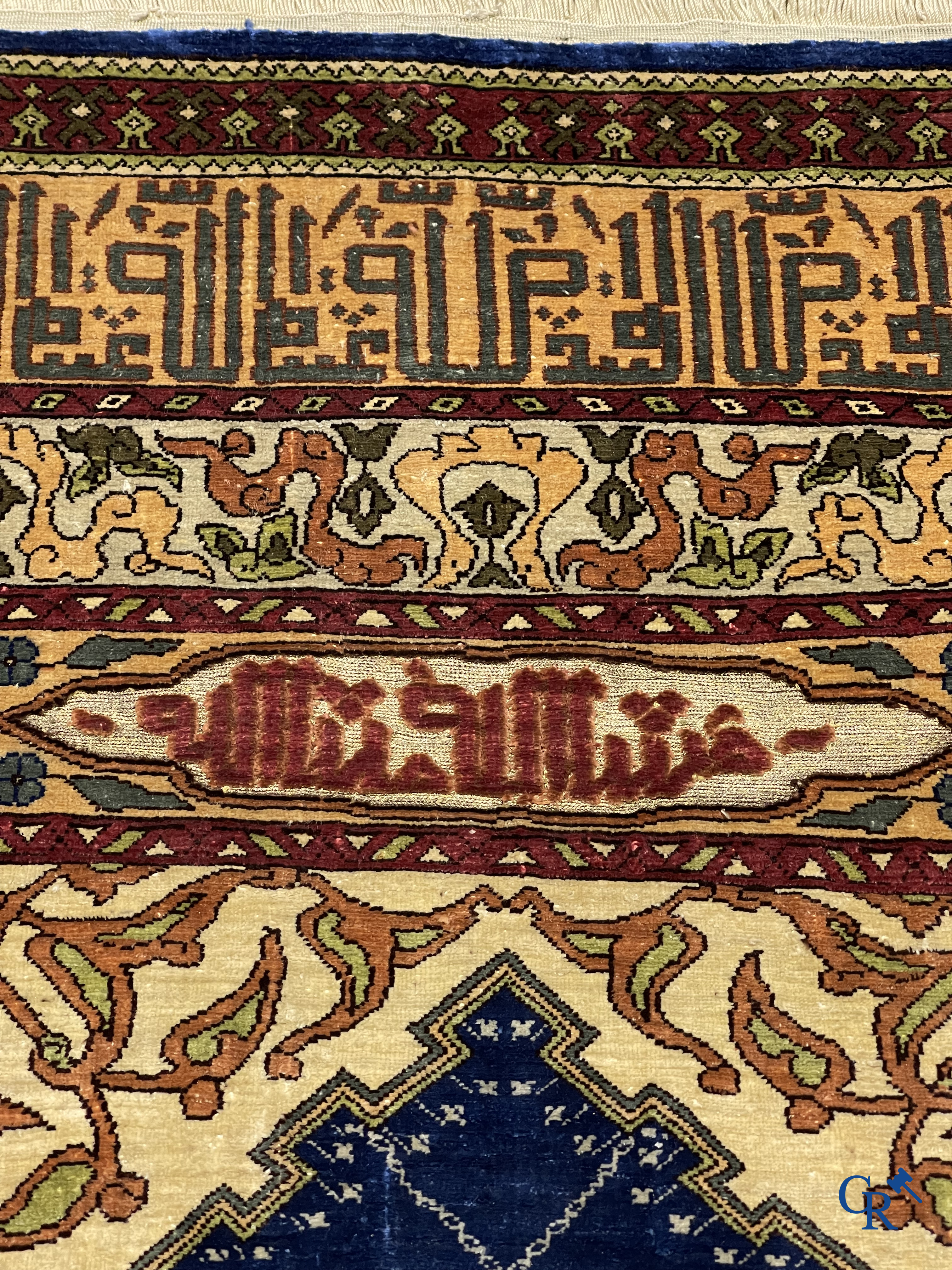 Oriental carpets. Extremely finely hand knotted silk carpet with inscriptions and gold thread. Signed.