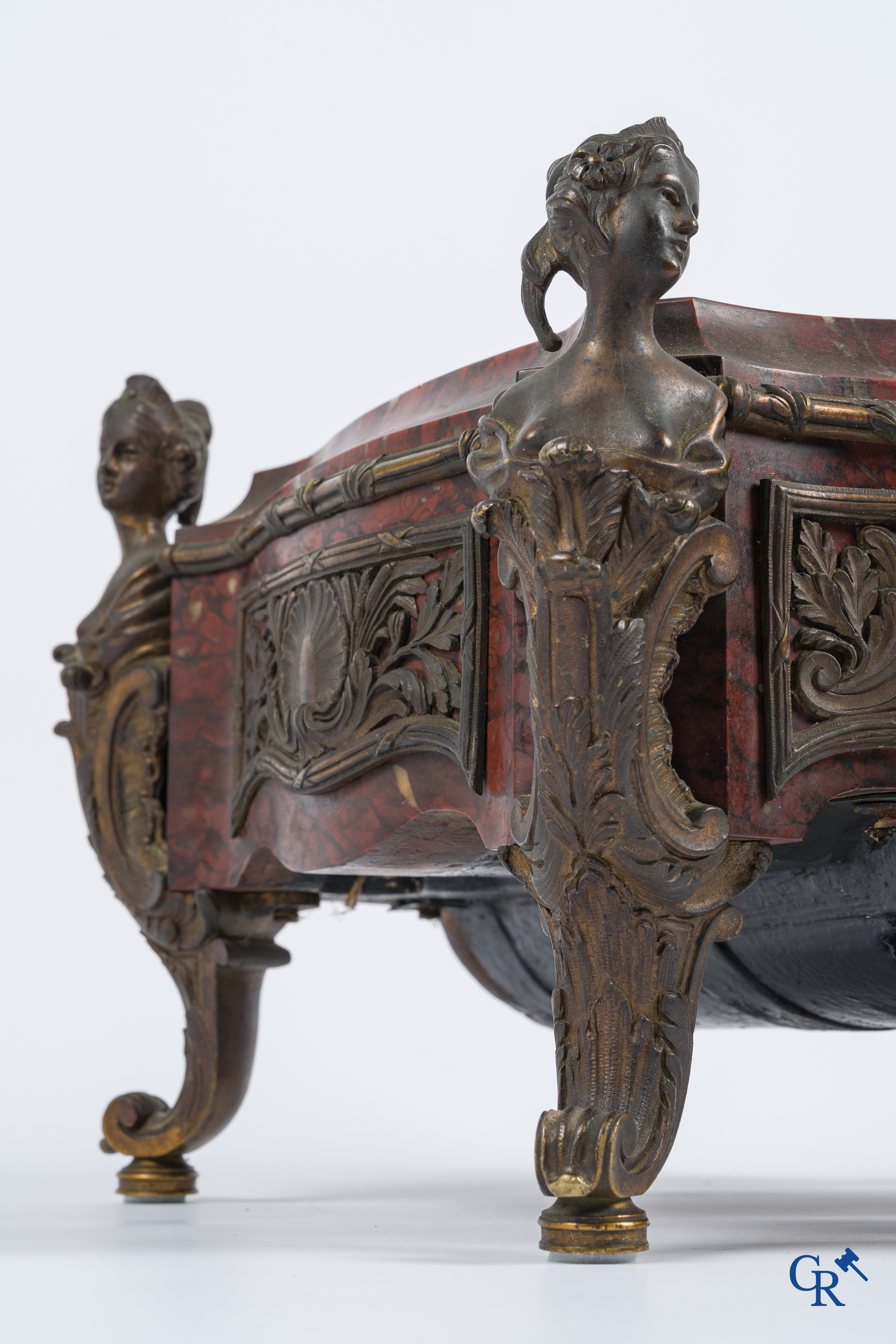 Napoleon III. A pedestal in marble and finely chiseled bronze with an incorporated clock. France, circa 1880.