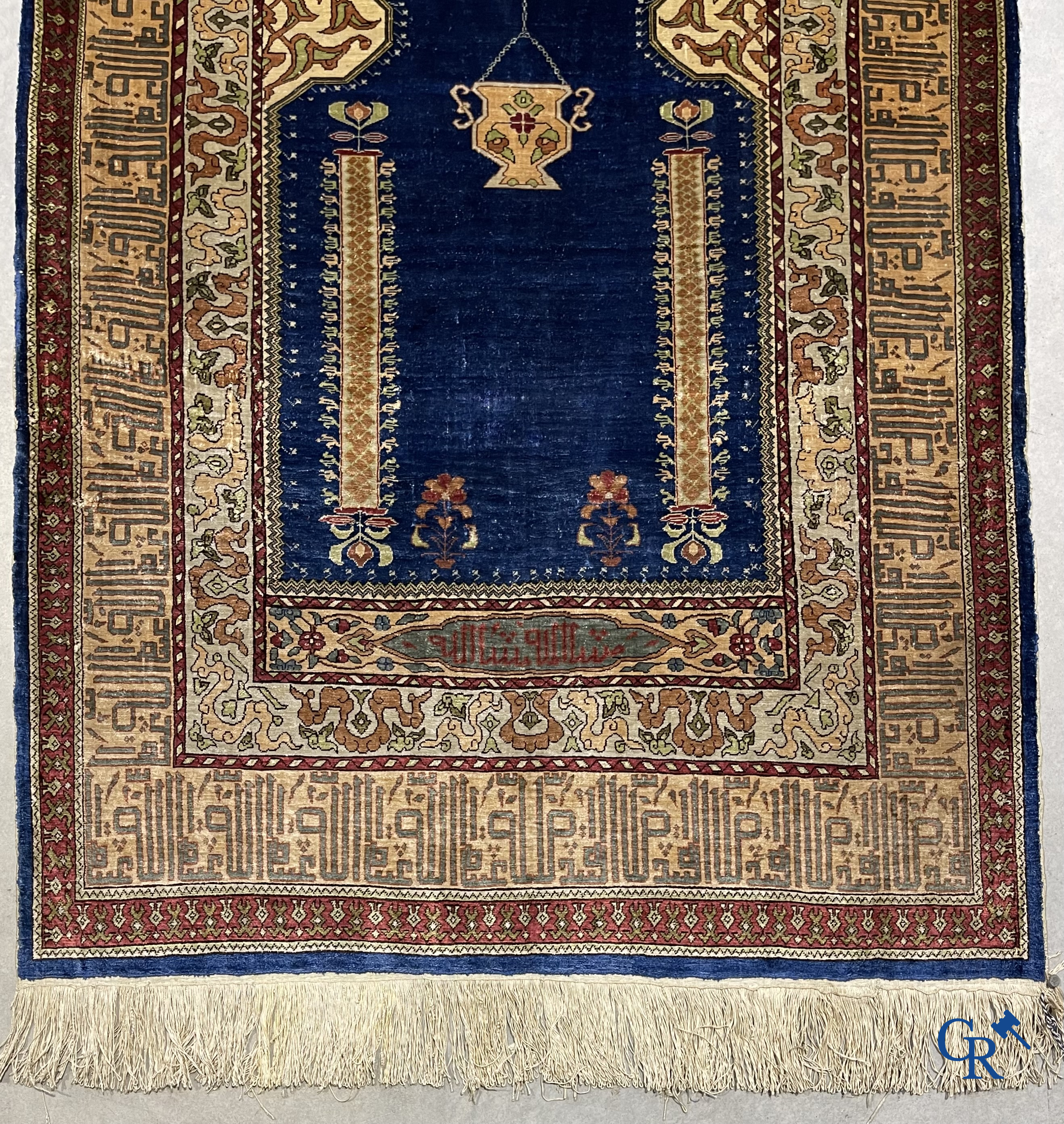 Oriental carpets. Extremely finely hand knotted silk carpet with inscriptions and gold thread. Signed.