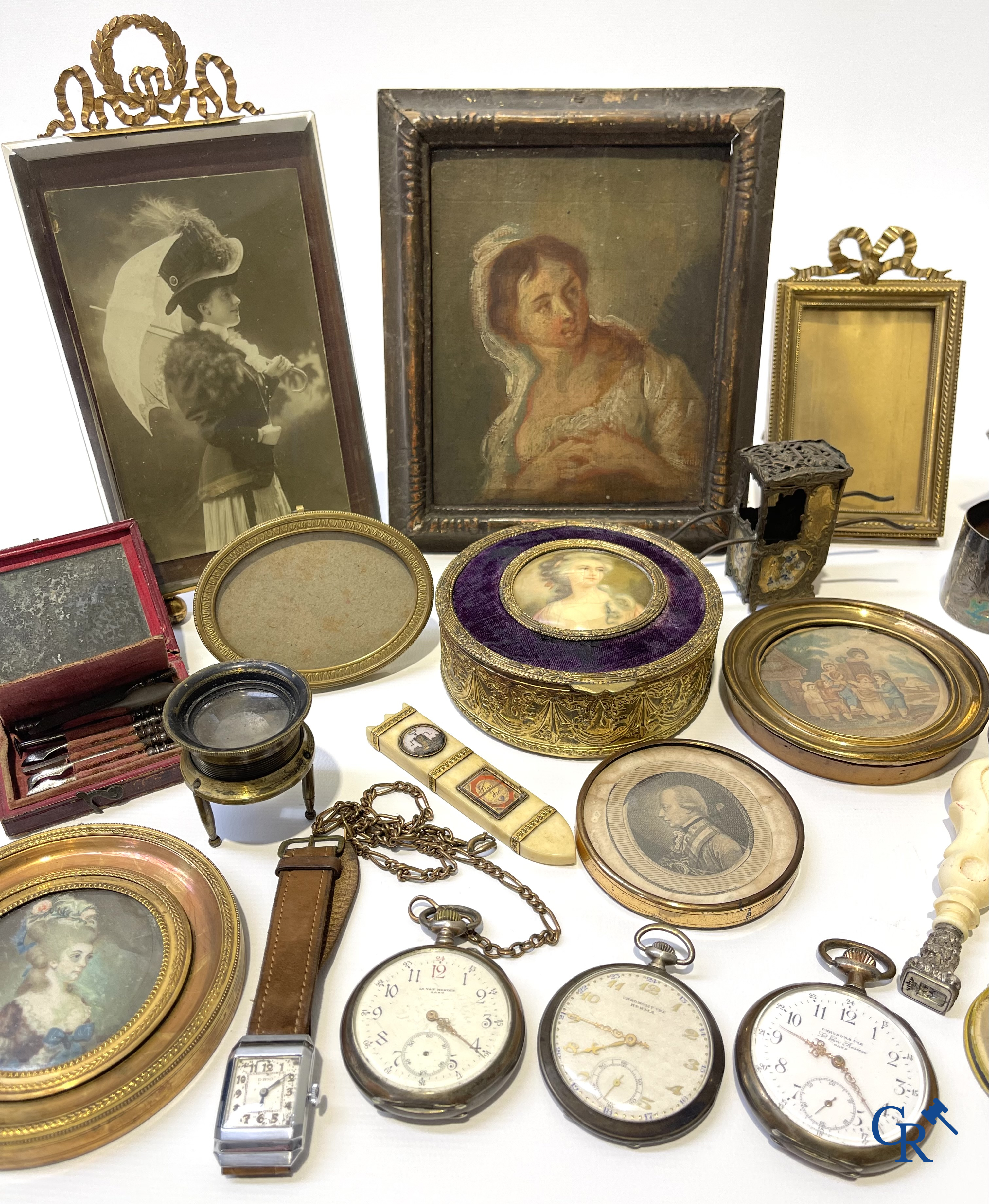 Een uitgebreid lot met vitrineobjecten. Zakhorloges, miniaturen, bronzen kaders, fantasiejuwelen enz. Sommige in zilver.