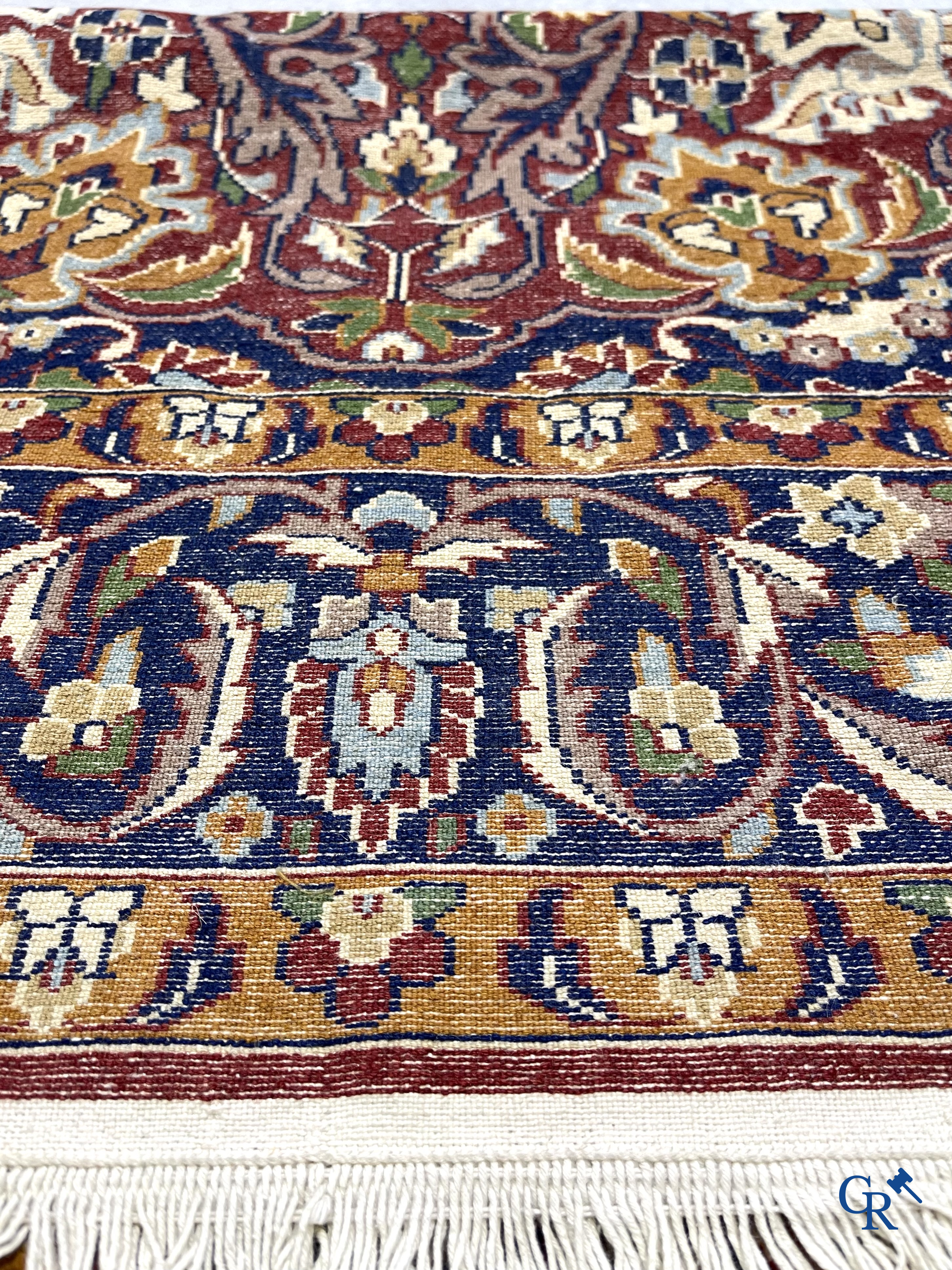 Oriental carpets. Finely hand-knotted carpet with floral decor on a dark red background.