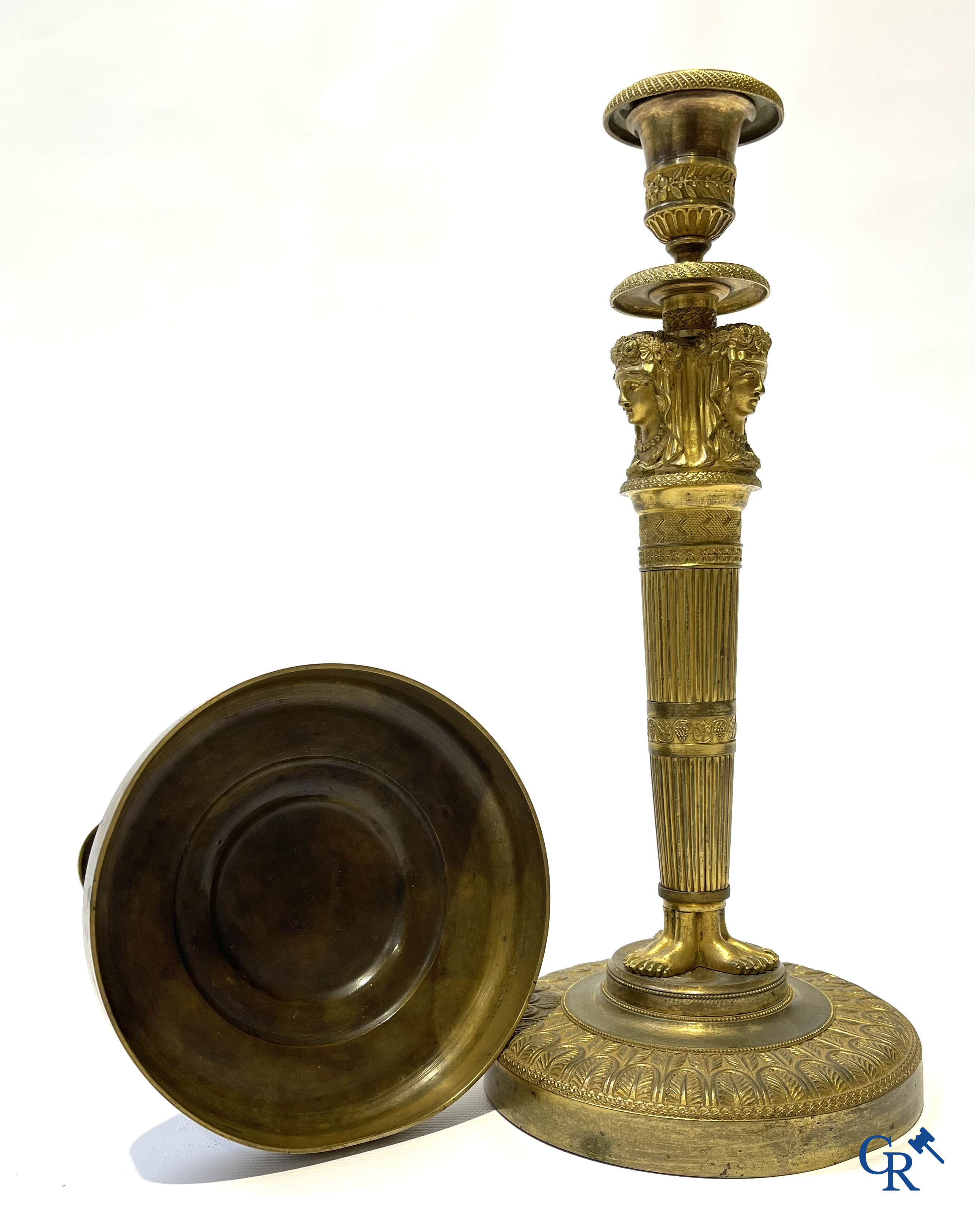 Empire. A pair of early 19th century bronze gilded candlesticks with caryatides. French work.
