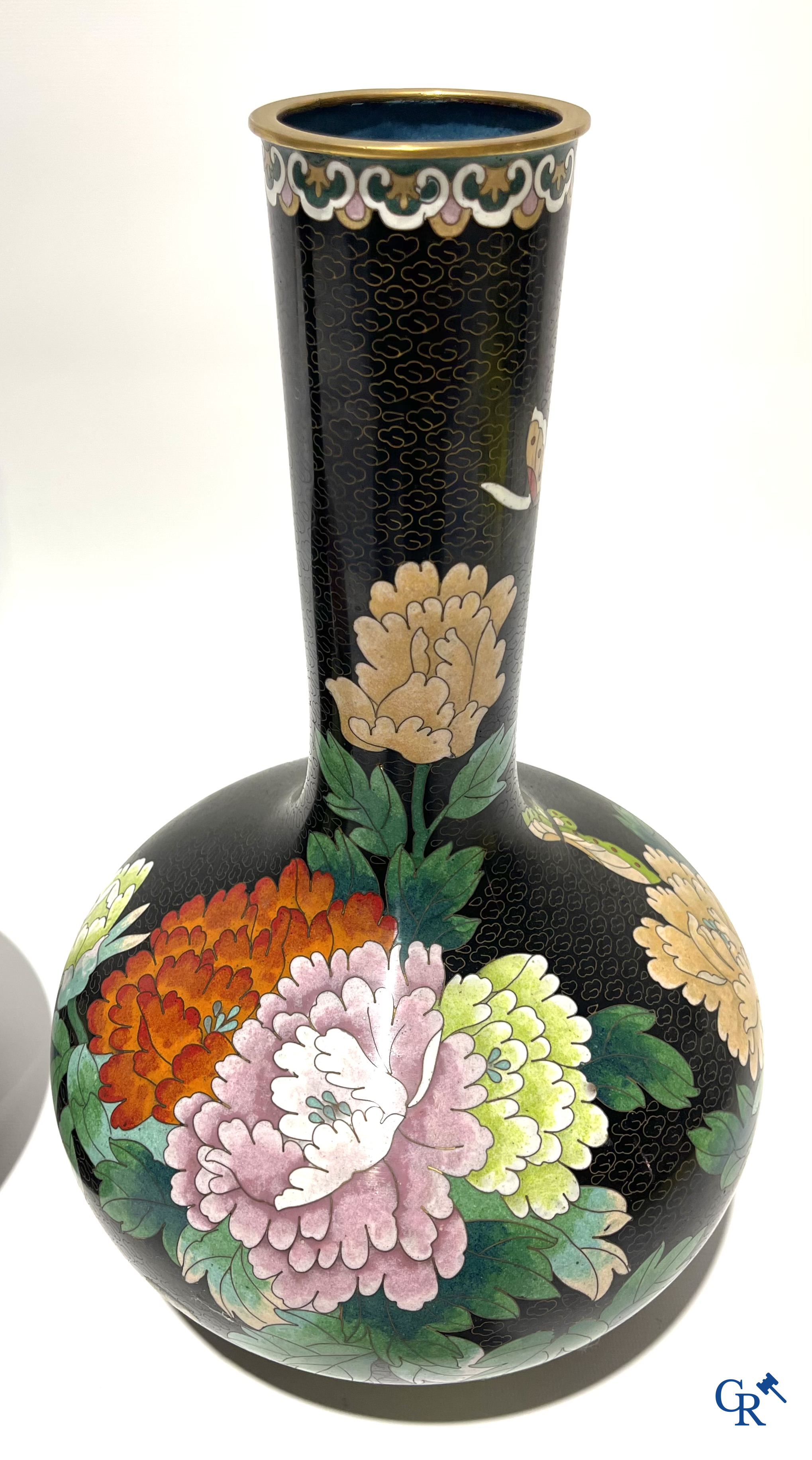 A pair of Chinese cloisonne vases with floral decor.