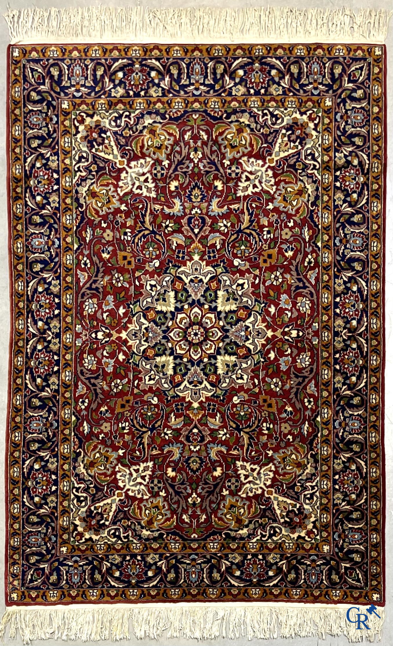 Oriental carpets. Finely hand-knotted carpet with floral decor on a dark red background.