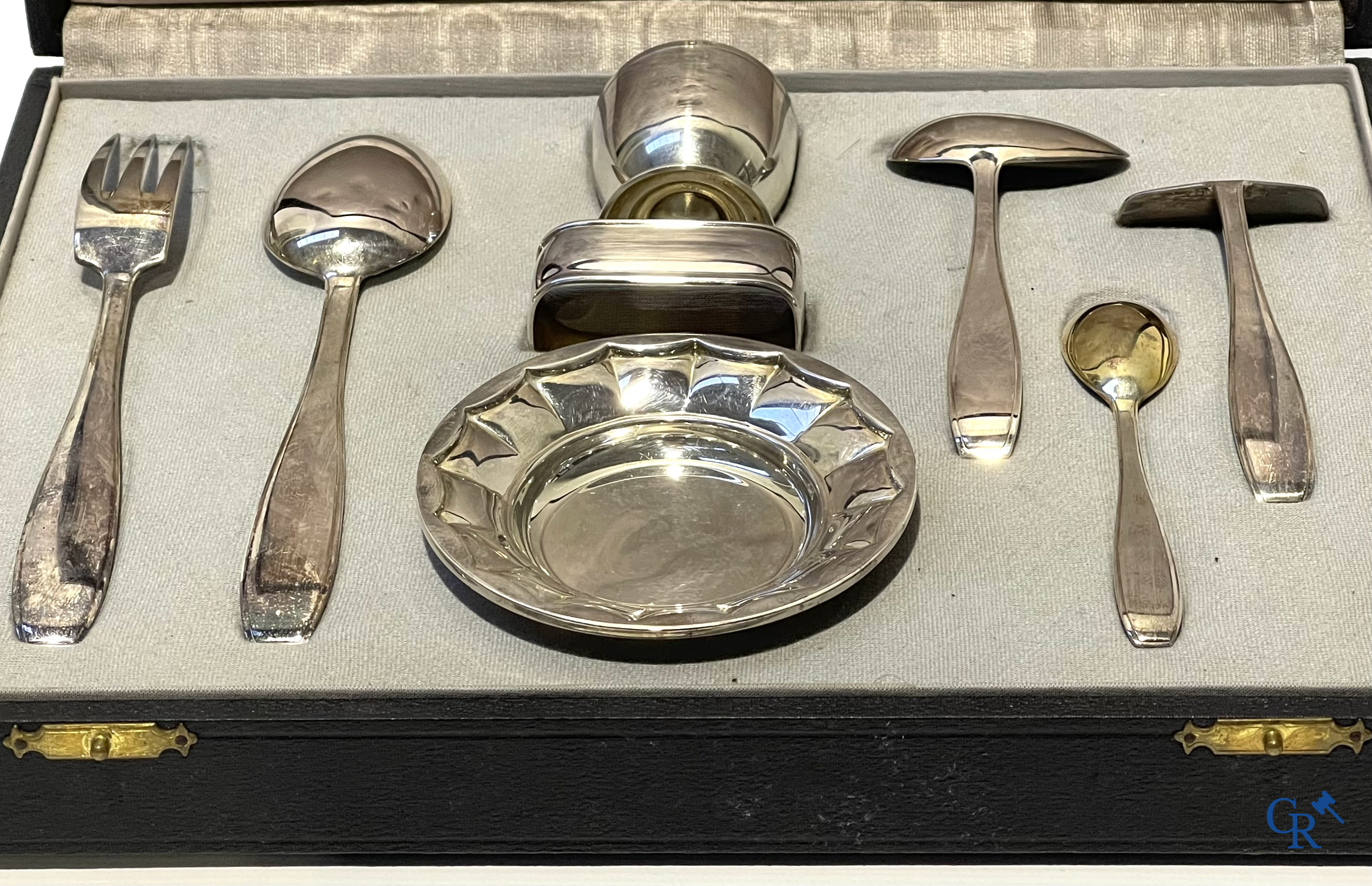 Wolfers Brussel. Geboorteset in vermeil 835°/00, de rammelaar 925°/00 en een set in zilver 835°/00. 20ste eeuw.