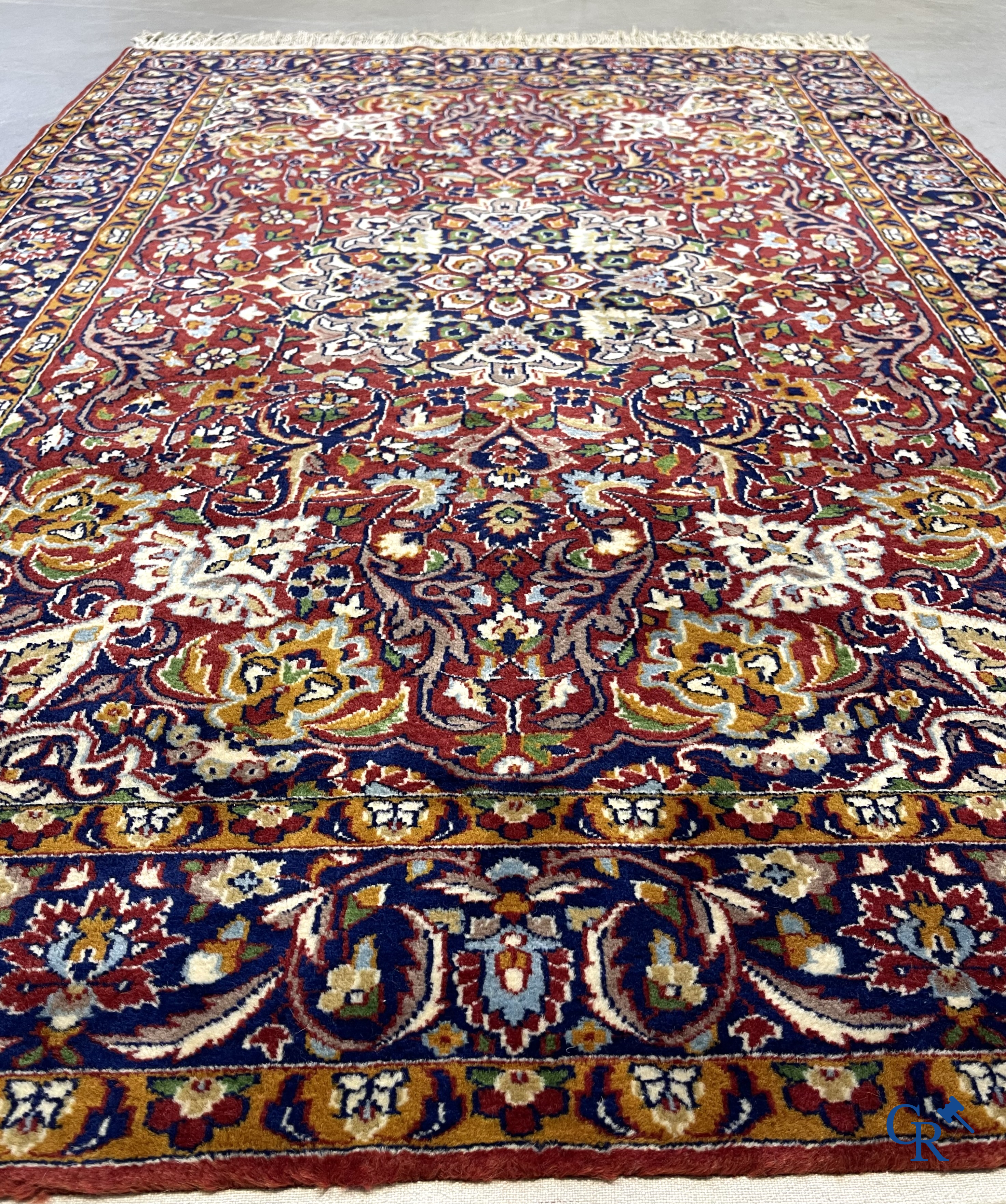 Oriental carpets. Finely hand-knotted carpet with floral decor on a dark red background.