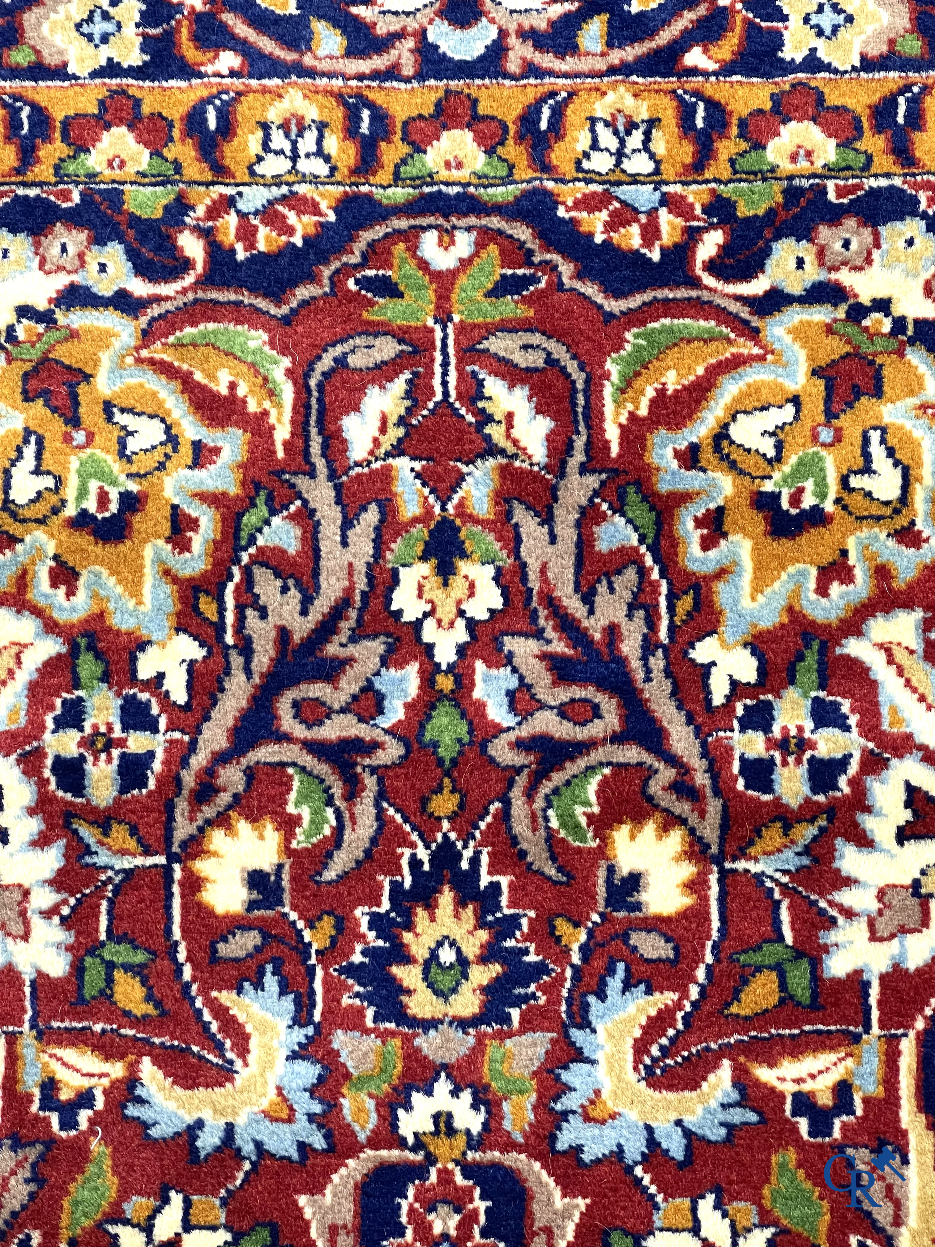 Oriental carpets. Finely hand-knotted carpet with floral decor on a dark red background.