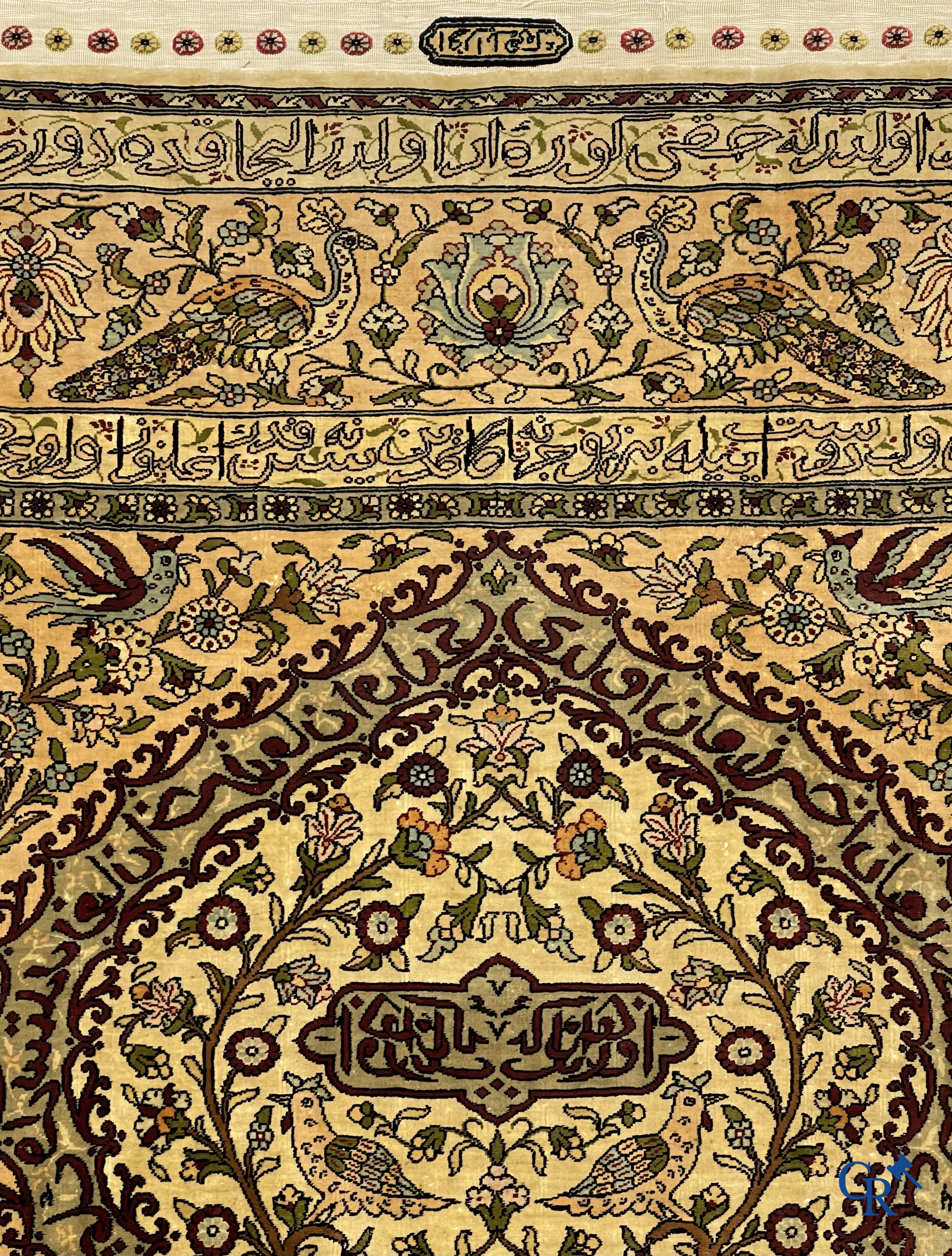 Oriental carpets. Hereke. A finely hand-knotted silk carpet with birds in the forest. Inscriptions and signed.