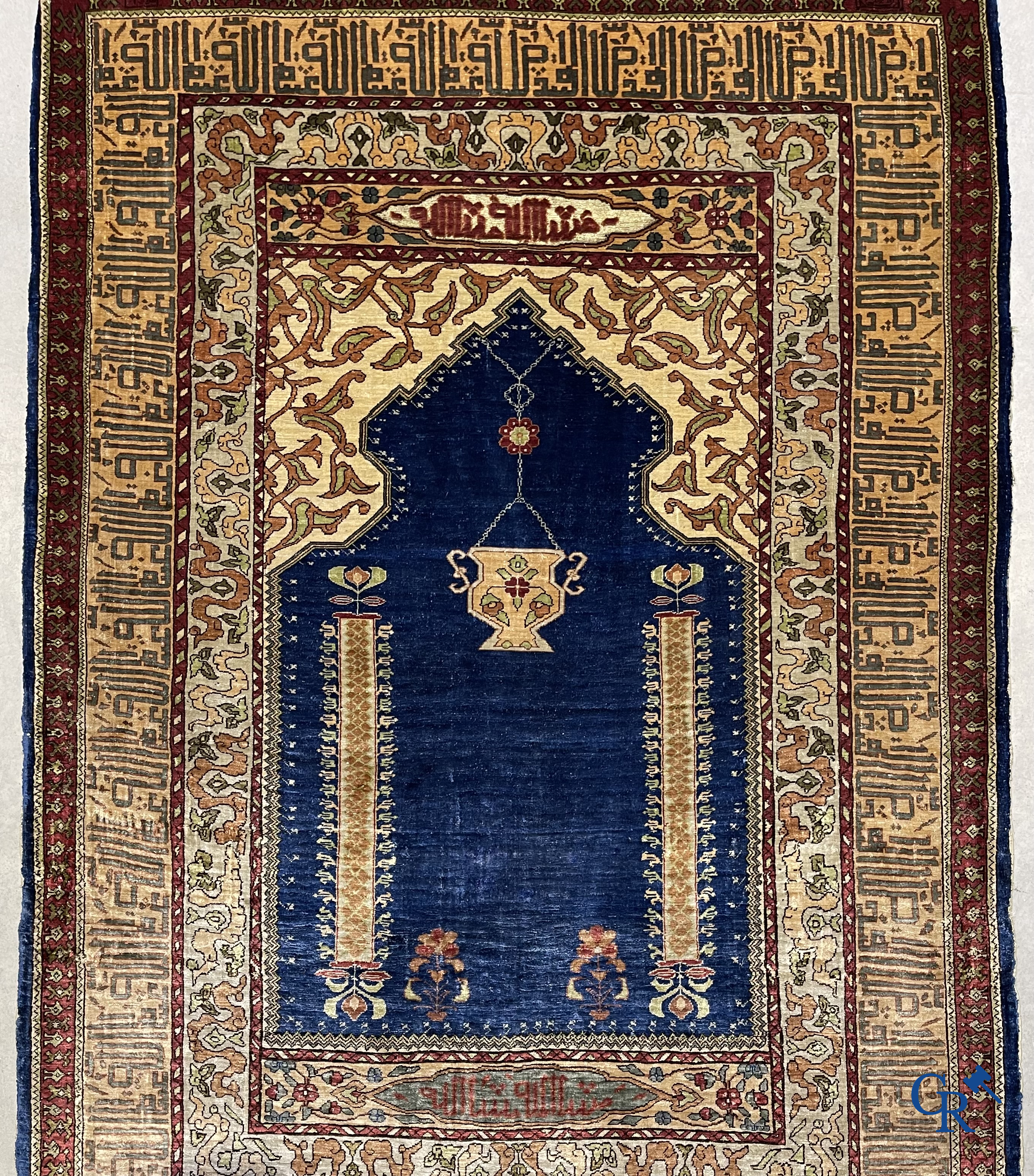 Oriental carpets. Extremely finely hand knotted silk carpet with inscriptions and gold thread. Signed.