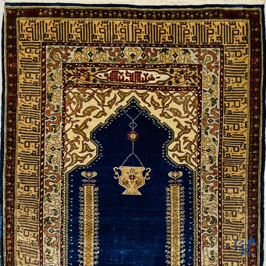 Oriental carpets. Extremely finely hand knotted silk carpet with inscriptions and gold thread. Signed.