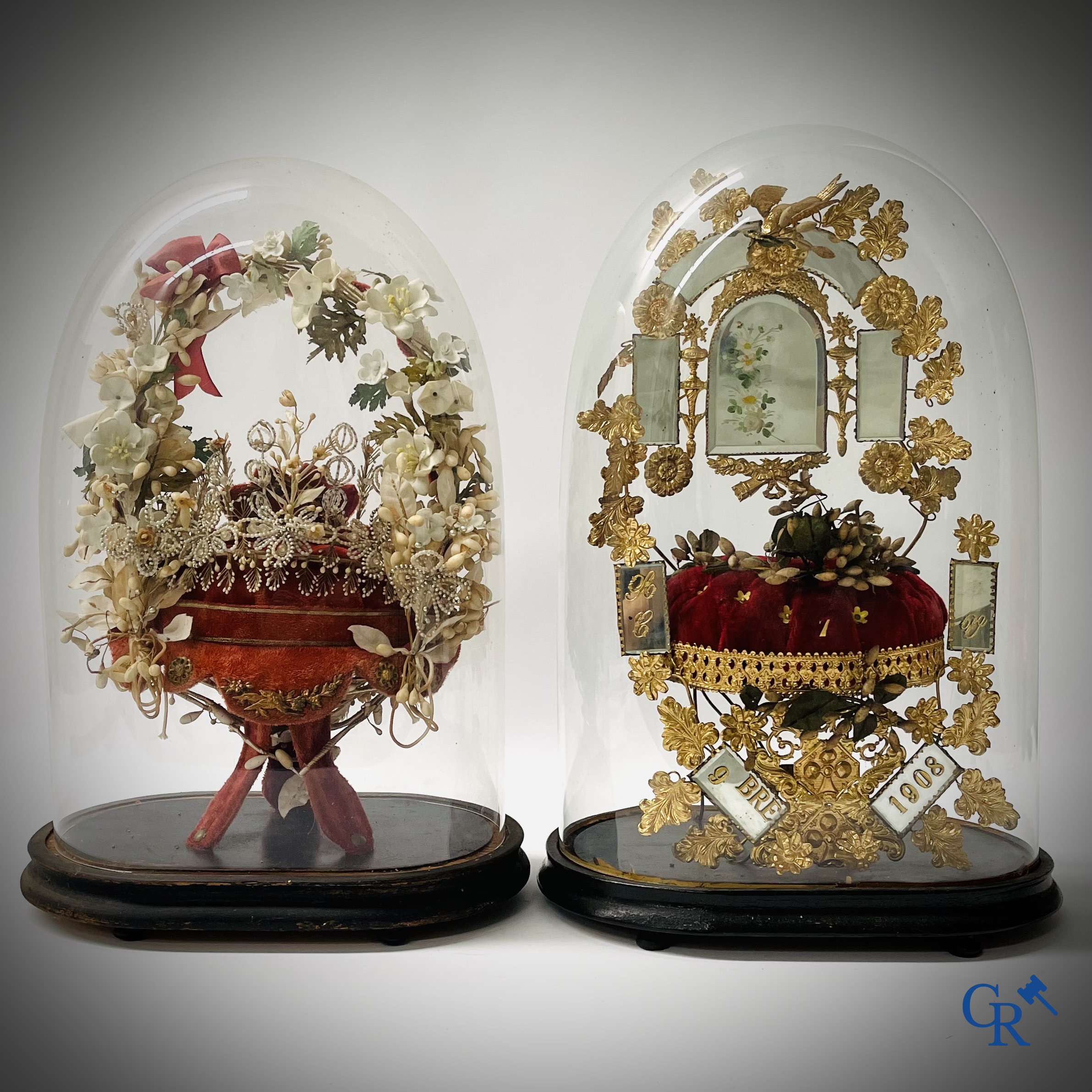 2 domes with wedding bouquet, one with flowers in biscuit, another with mirrors, dated 1908.