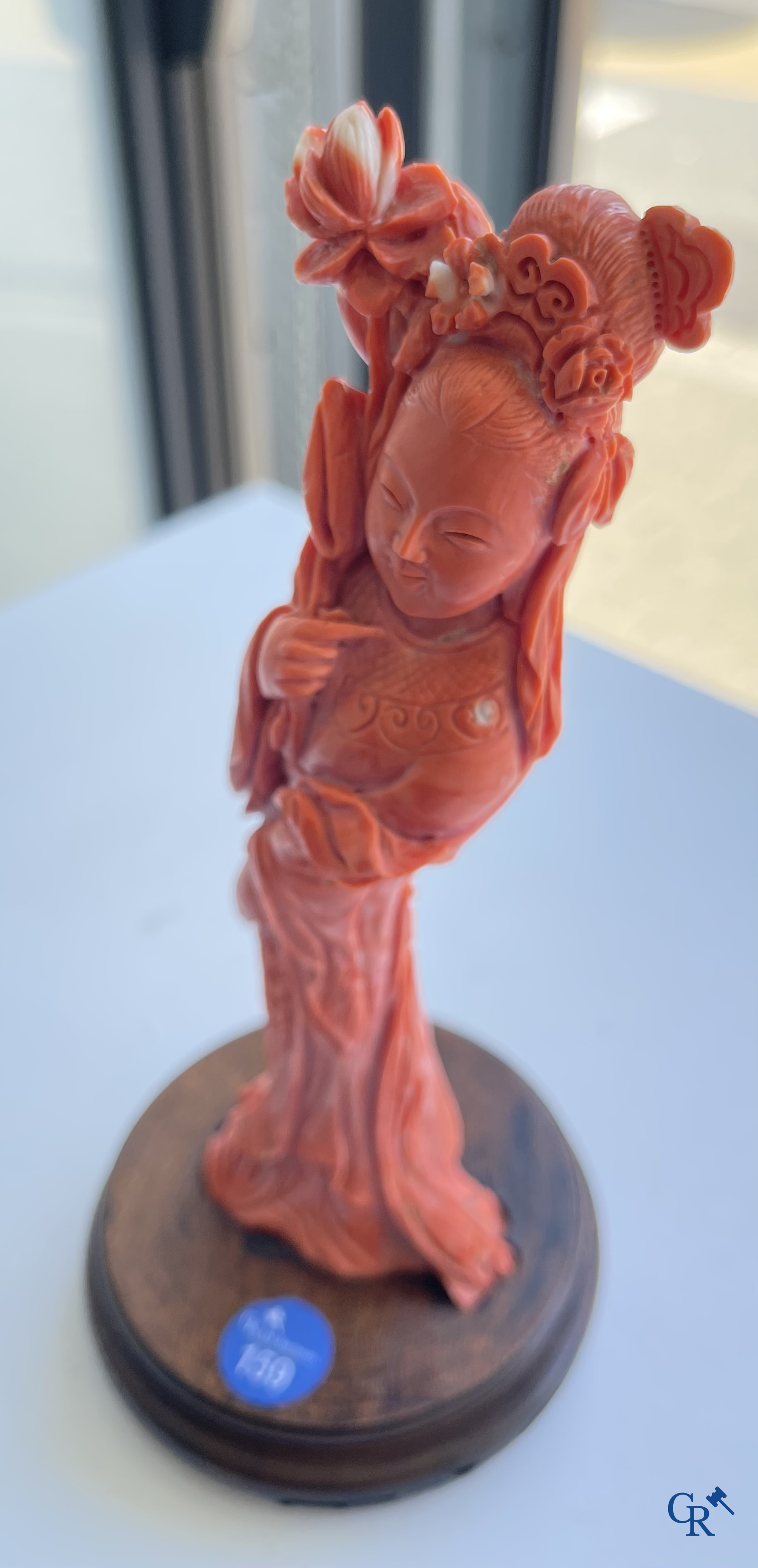Asian Art, China. A red coral figure of a Chinese lady on a wooden pedestal.
