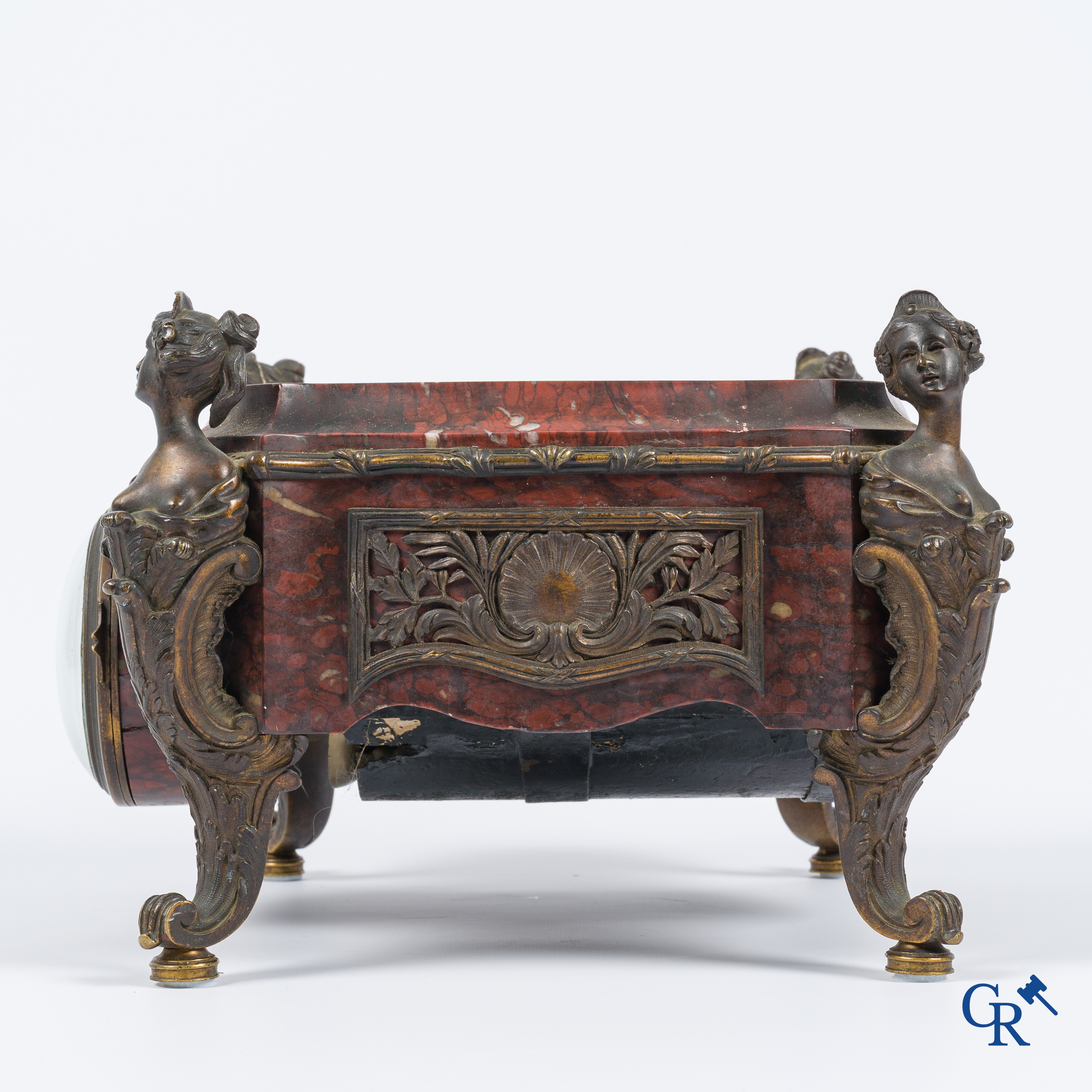 Napoleon III. A pedestal in marble and finely chiseled bronze with an incorporated clock. France, circa 1880.